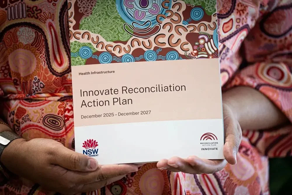 Hands holding a Reconciliation Action Plan document