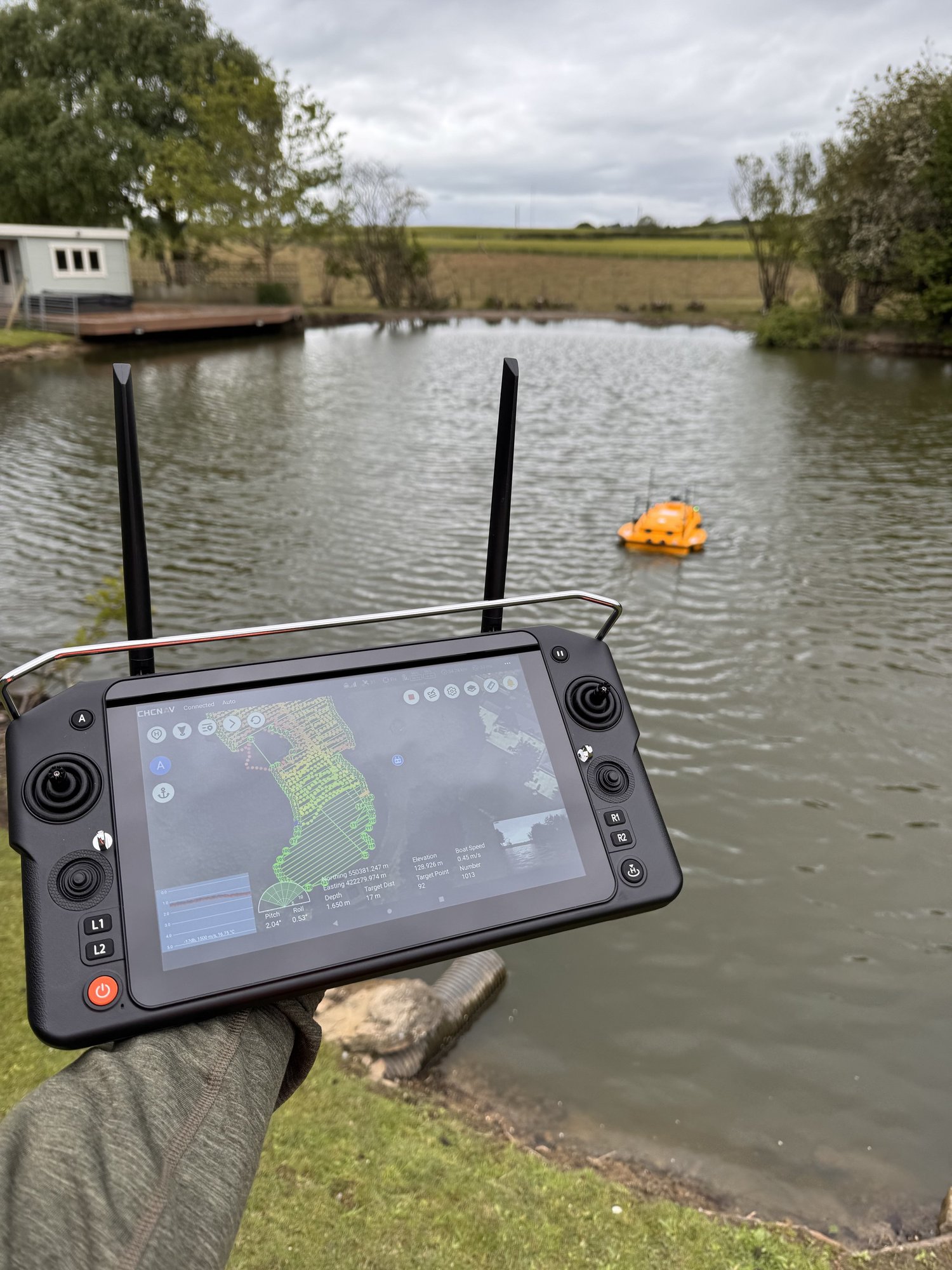 Remote-controlled survey boat carrying out a bathymetric survey