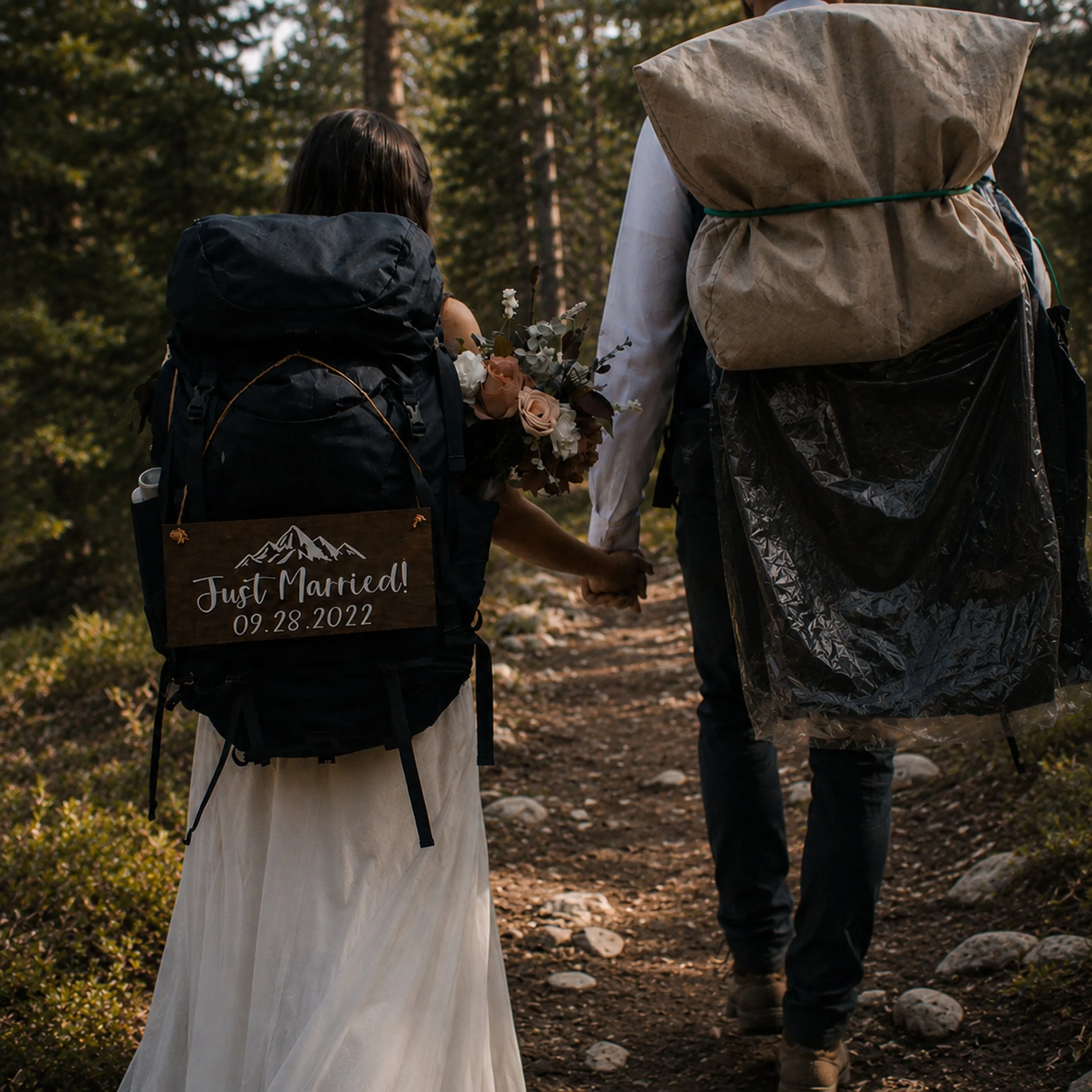Just married couple hiking together on their elopement day
