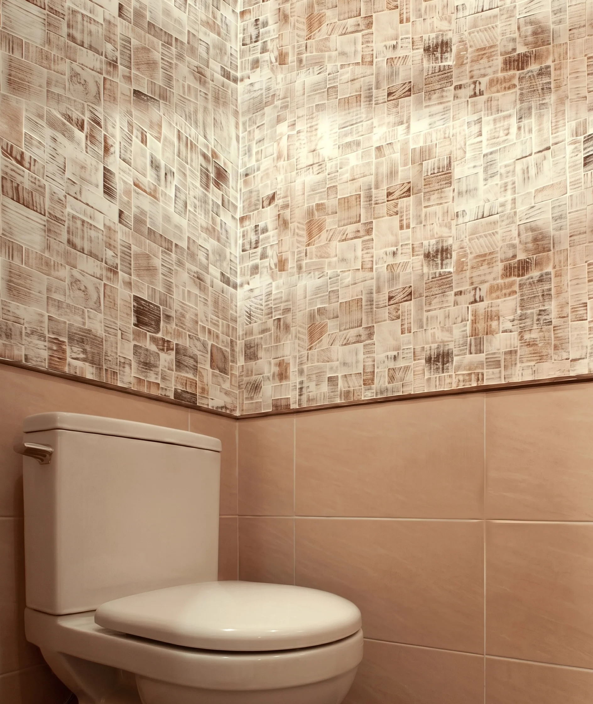 Powder room with beige tiles and decorative wall