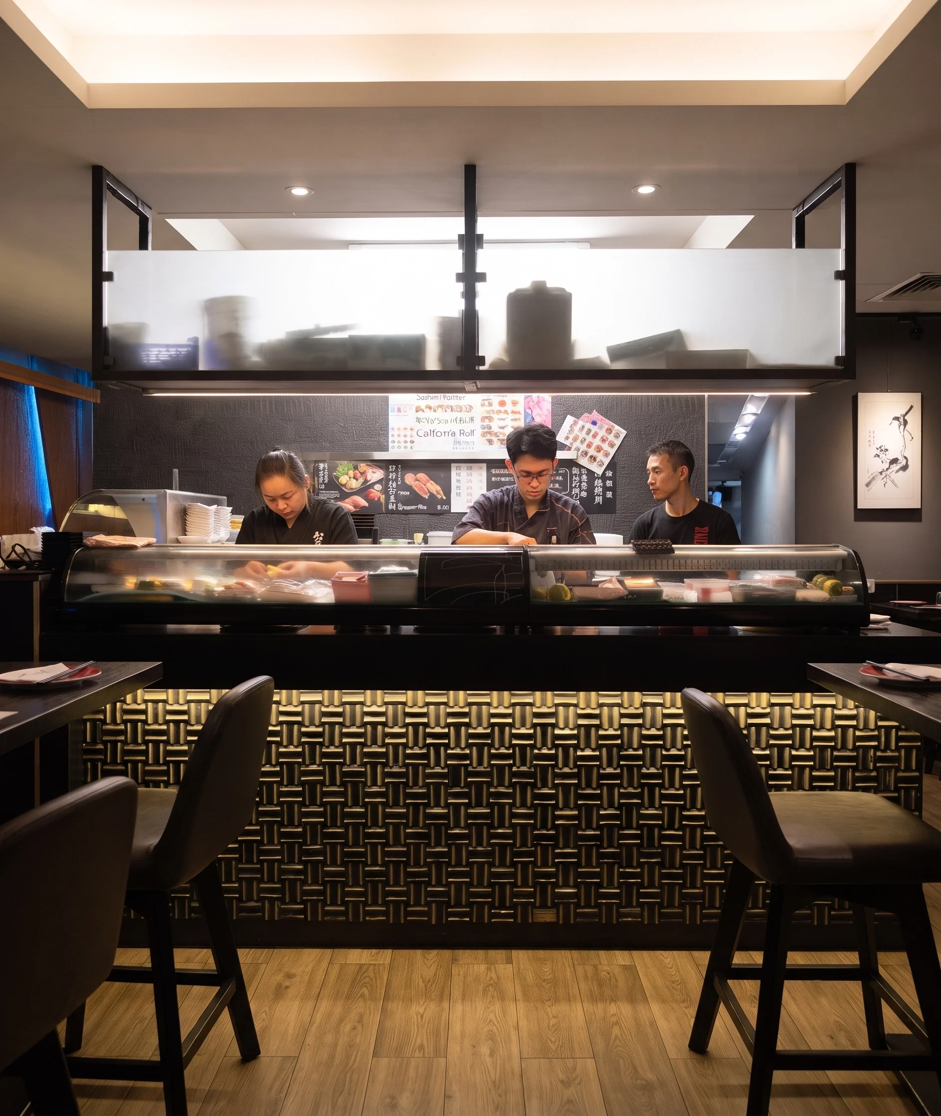Sushi bar with chefs behind the counter