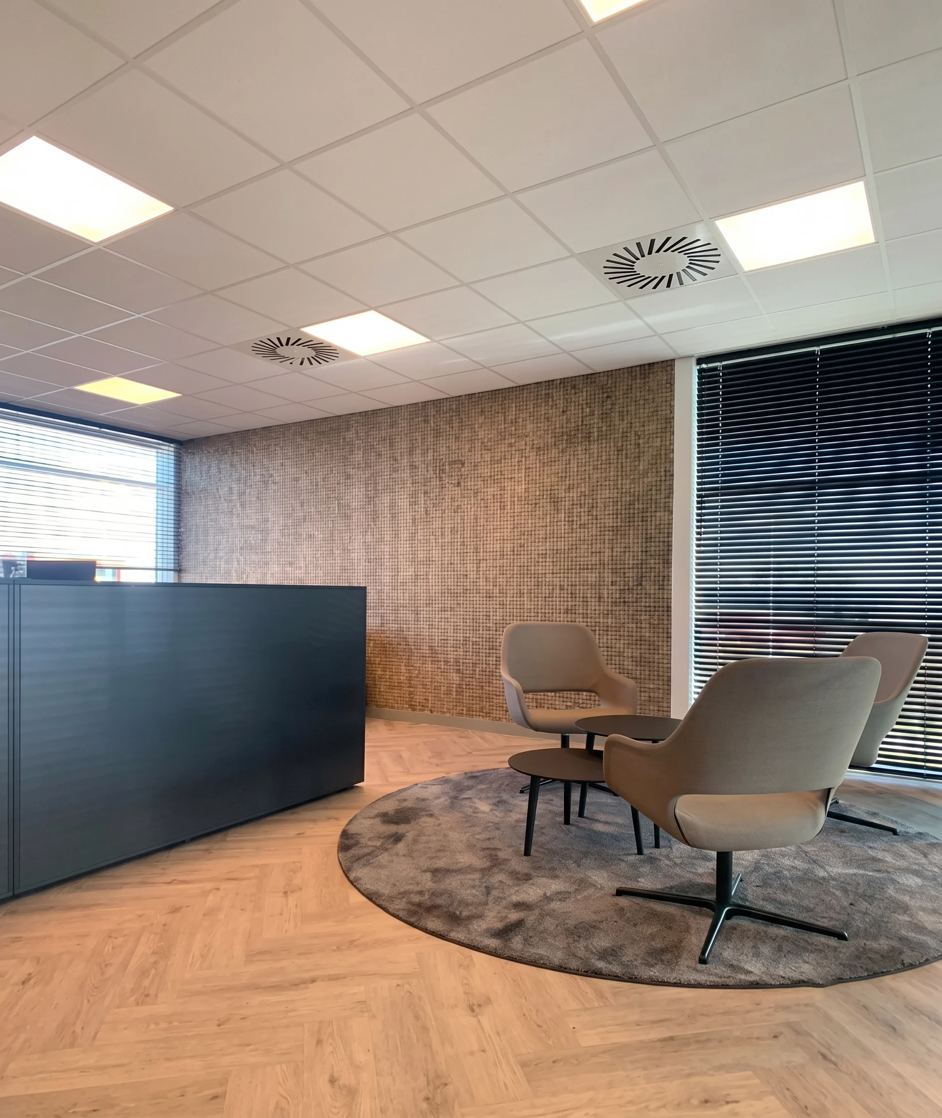 Office lounge with armchairs around a round table