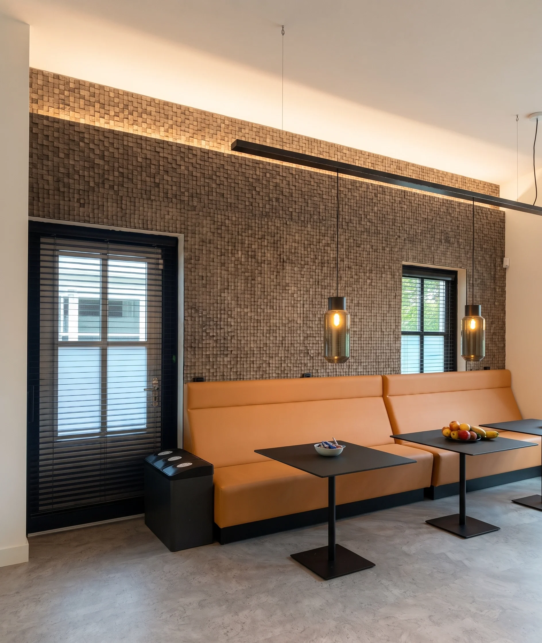 Modern lounge with textured brick wall and bench seating