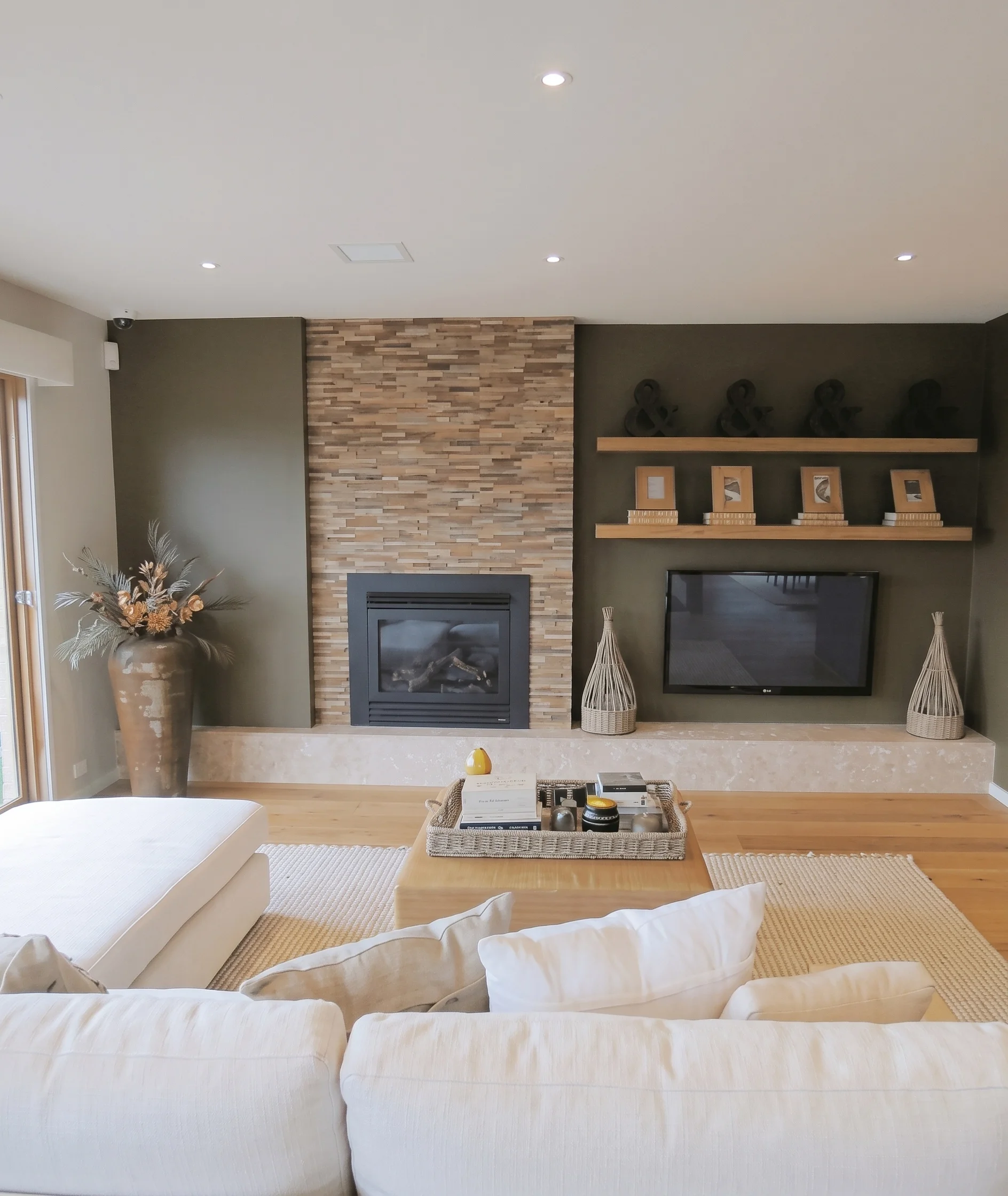 Living room with fireplace and wooden shelves