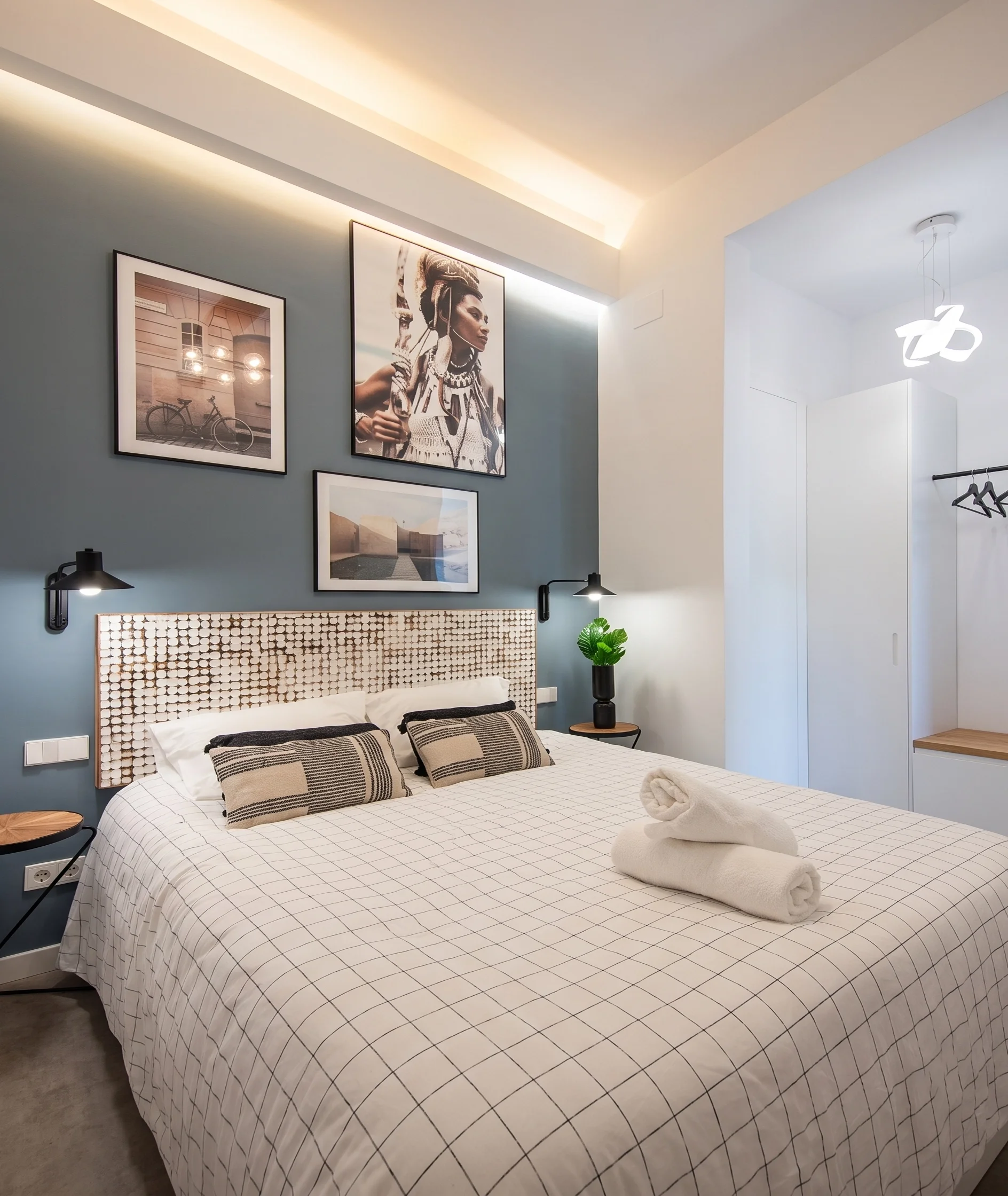 Bedroom with blue accent wall and textured headboard