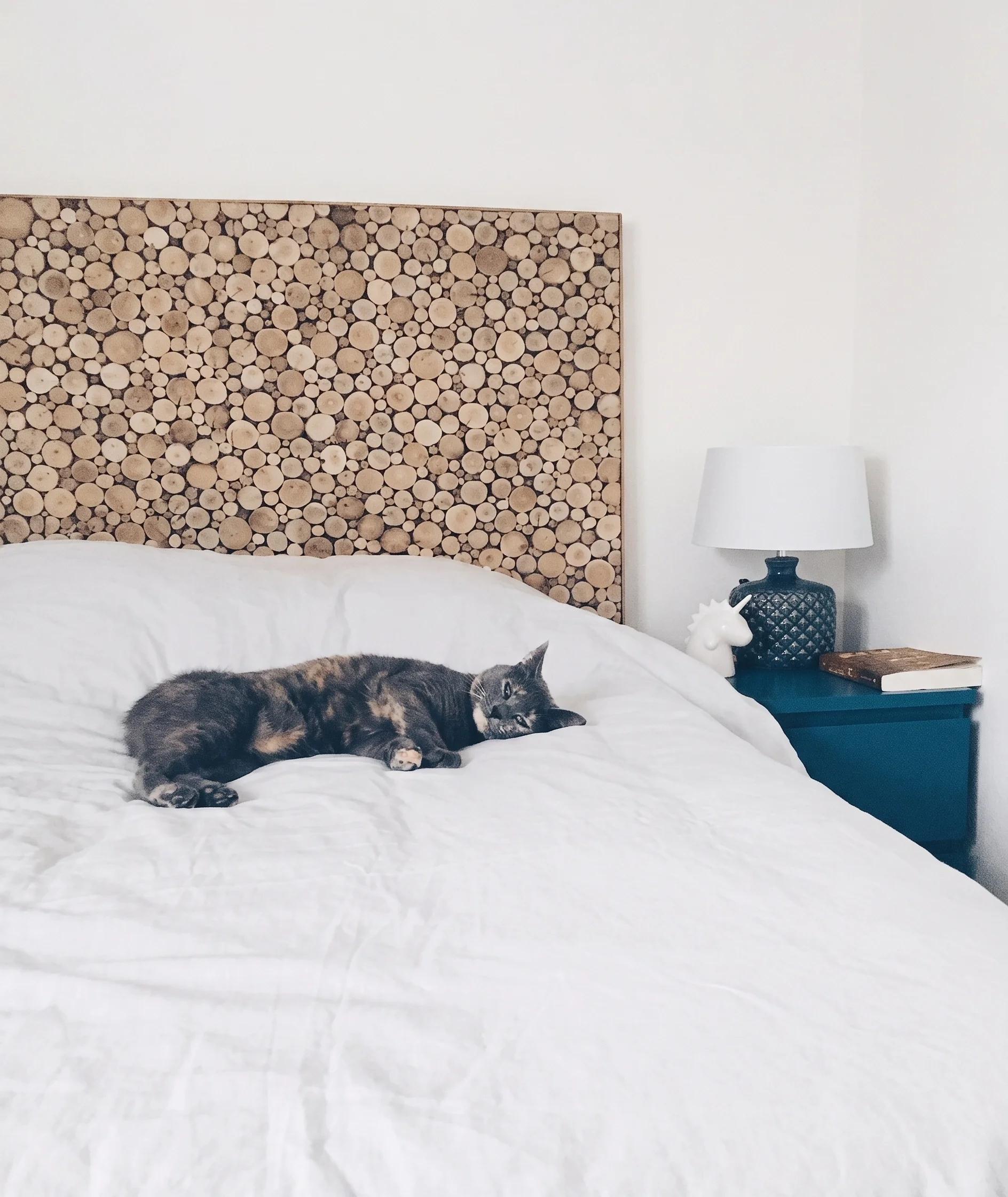 Bedroom with headboard made of stacked wood logs