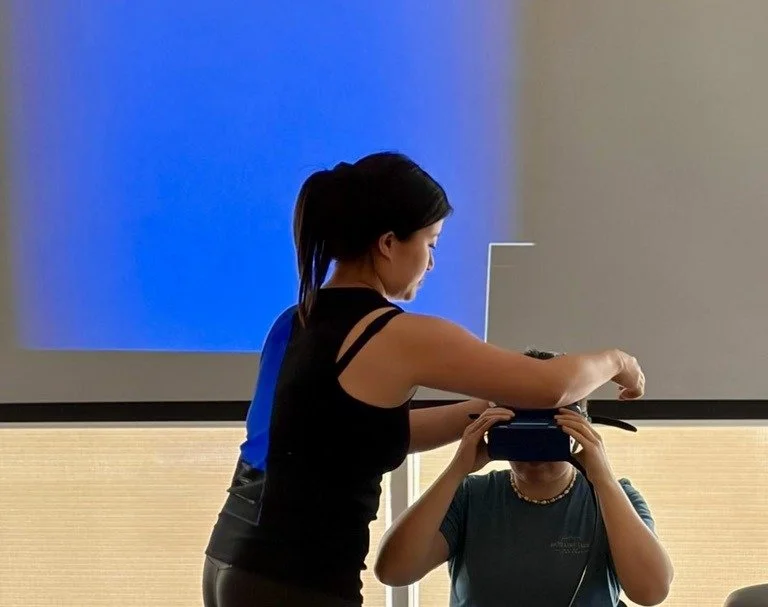 Sonia Vovan fitting infrared video goggles during a vestibular course demonstration