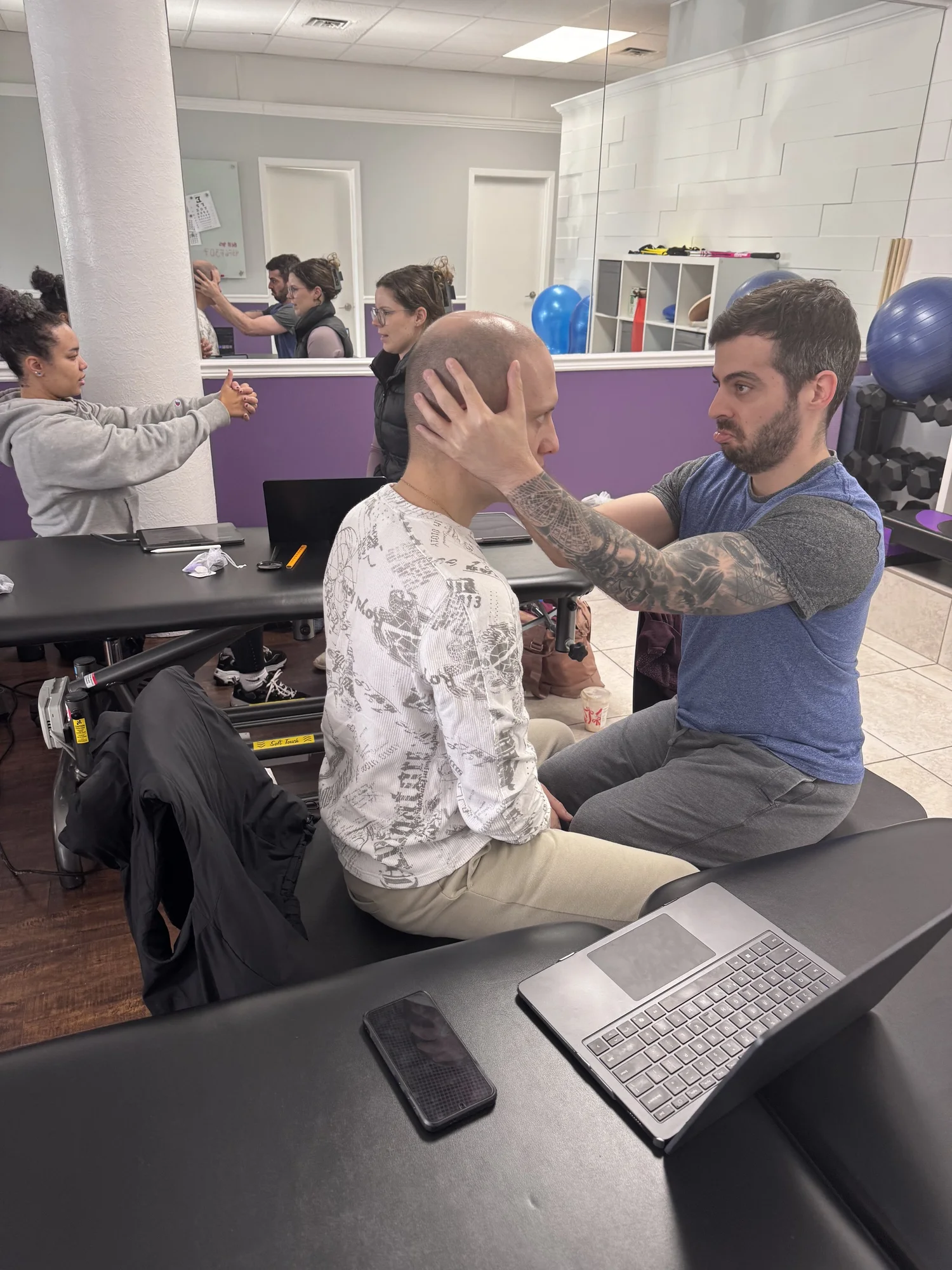 Clinicians practising hands-on skills in a course workshop