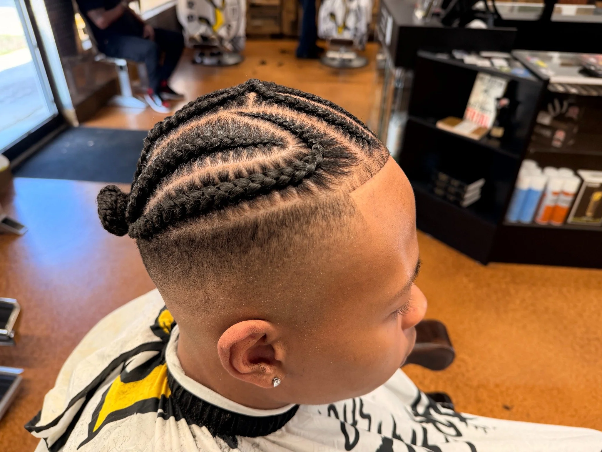 Braids with a clean taper at Barber Skate Shop