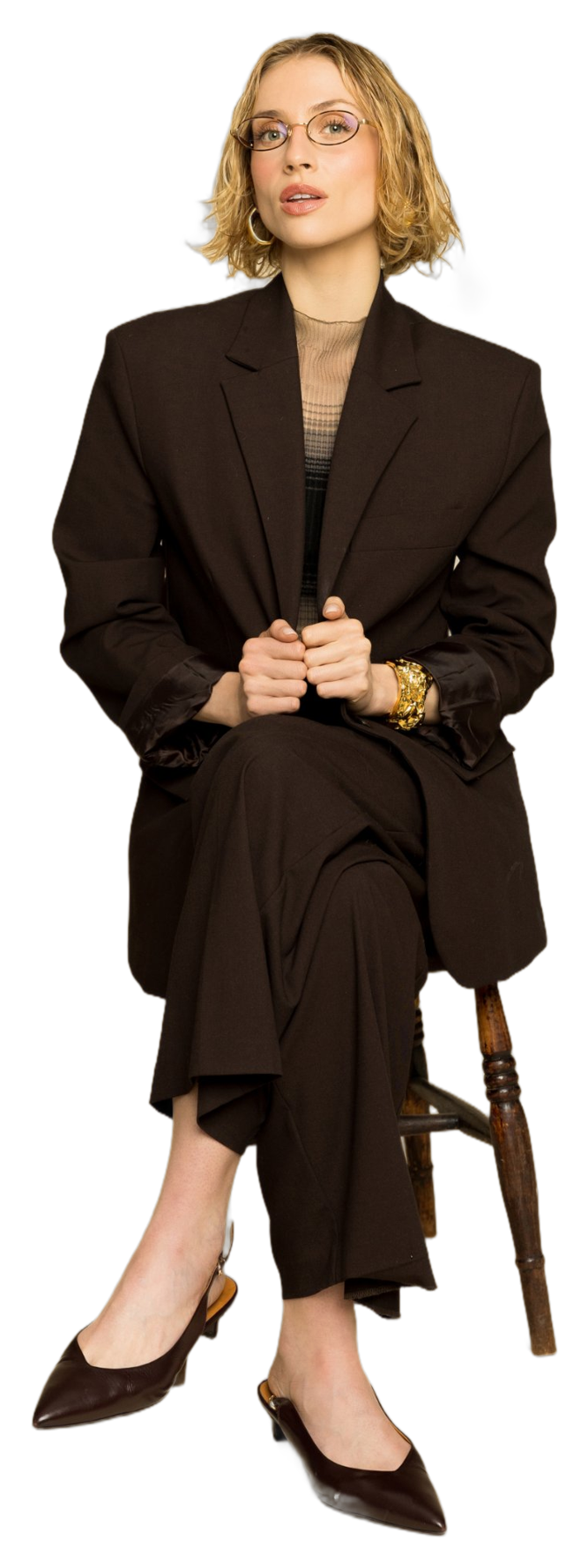 Emma-Louise Boynton, host of Sex Talks, standing in a brown suit and glasses