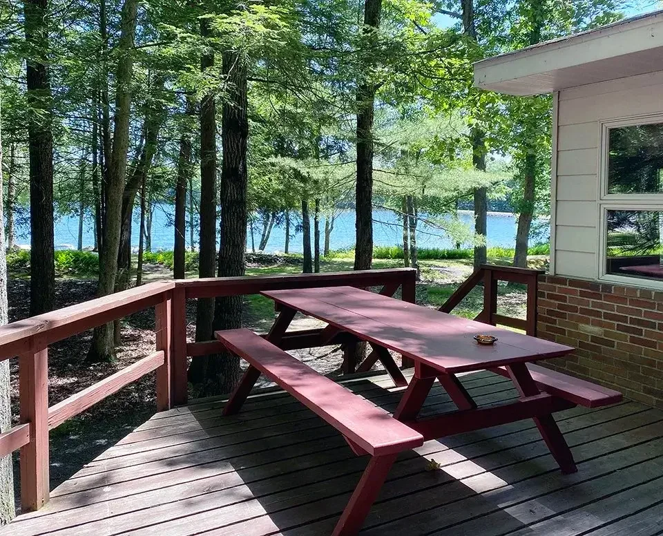 Cabin 42 deck with picnic table overlooking the lake