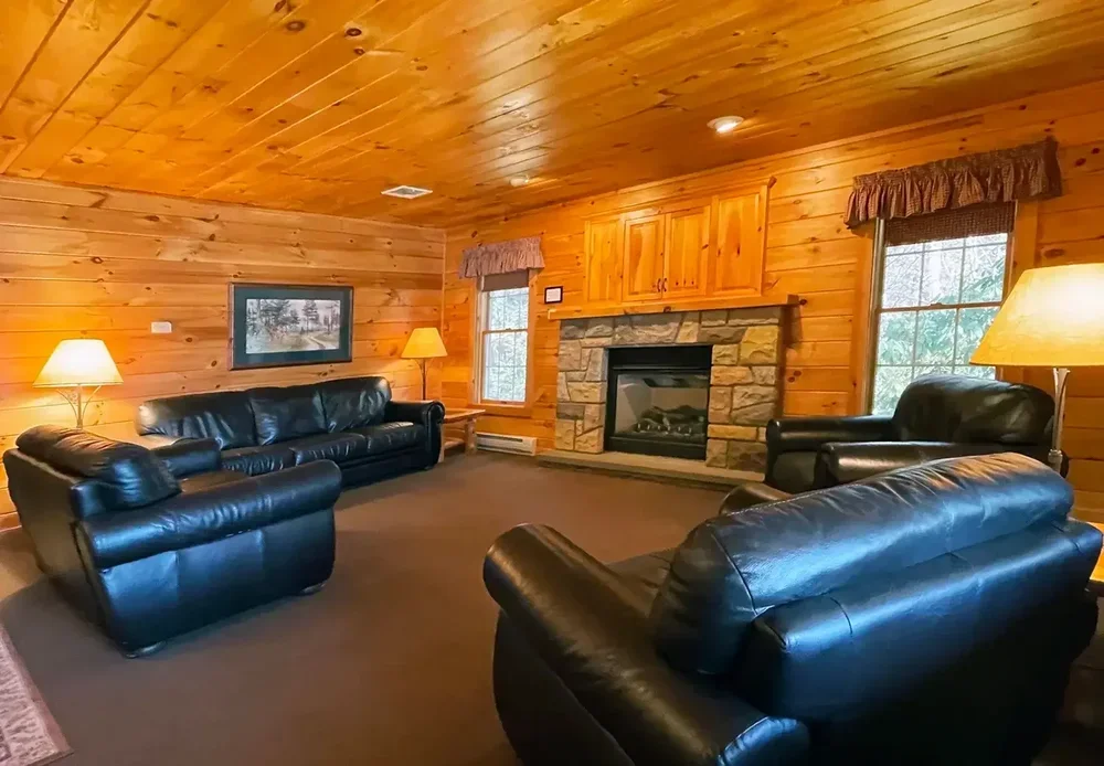 Living room with gas fireplace and comfortable seating inside Hemlock Cabin #62