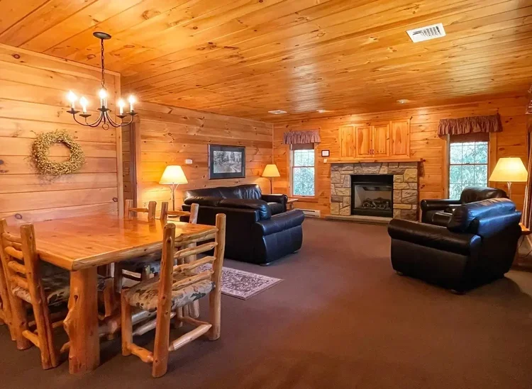 Hemlock Cabin 62 open living and dining area with wood interior at Mountain Springs Lake Resort
