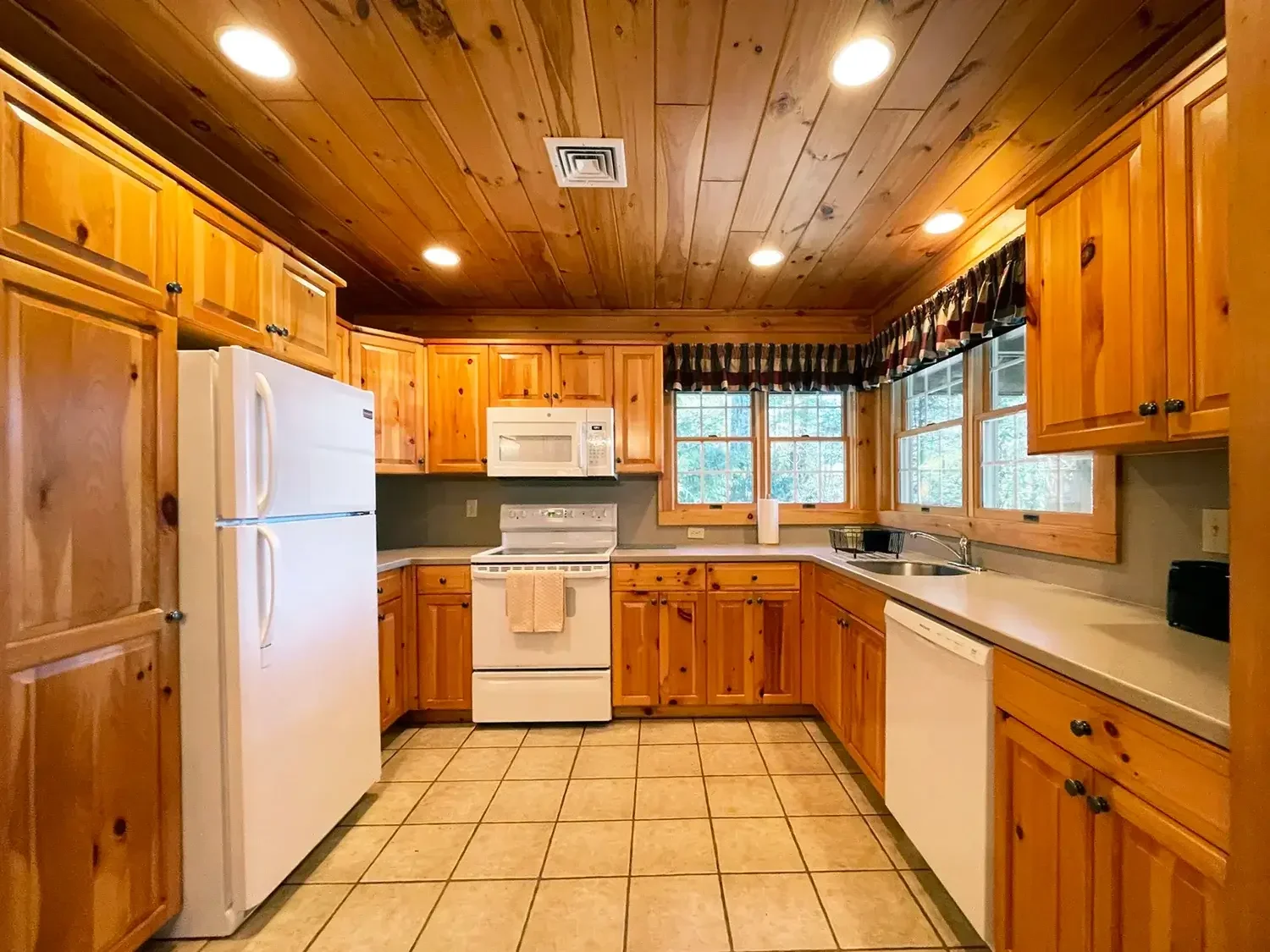 Hemlock Cabin 64 full kitchen with wood cabinets at Mountain Springs Lake Resort