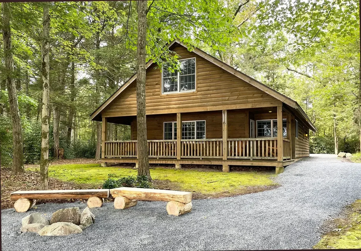 Hemlock Cabin 64 exterior front porch and fire pit at Mountain Springs Lake Resort