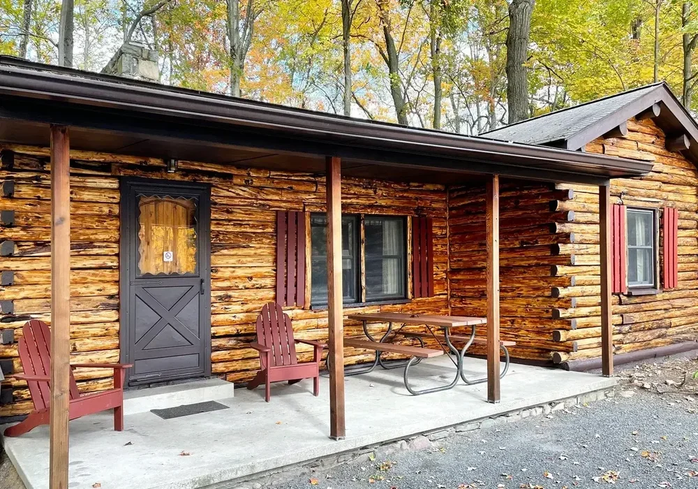 Lakeview Cabin 3 exterior with covered porch and autumn trees