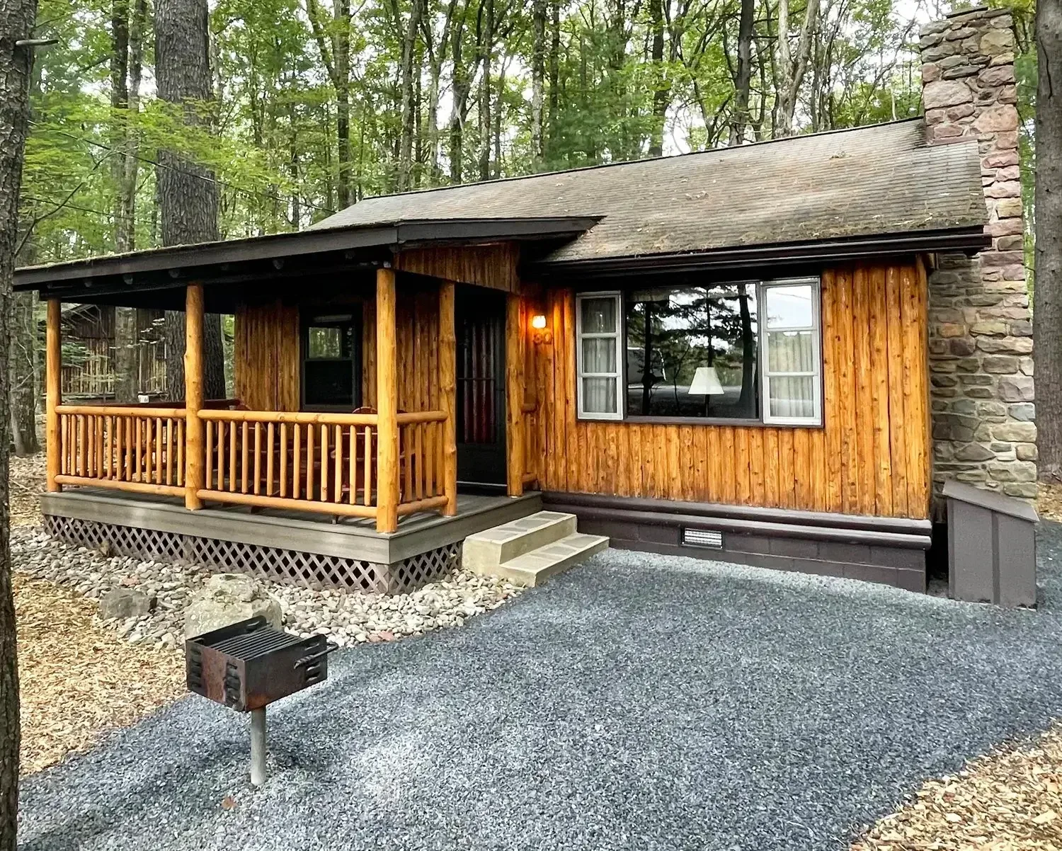 Woodside Cabin 30 exterior with porch and charcoal grill