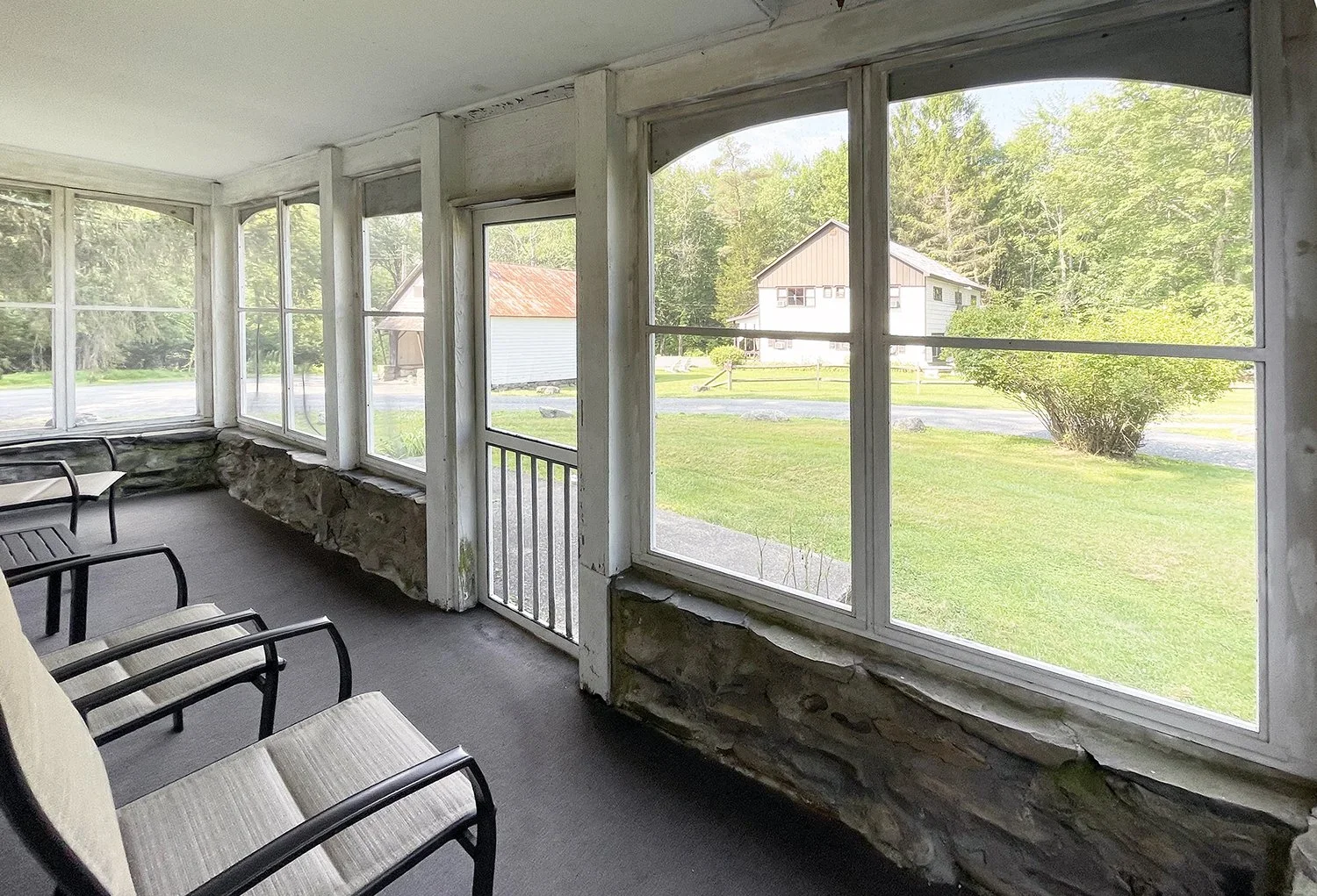Farmhouse 17 screened-in porch with outdoor seating and property views