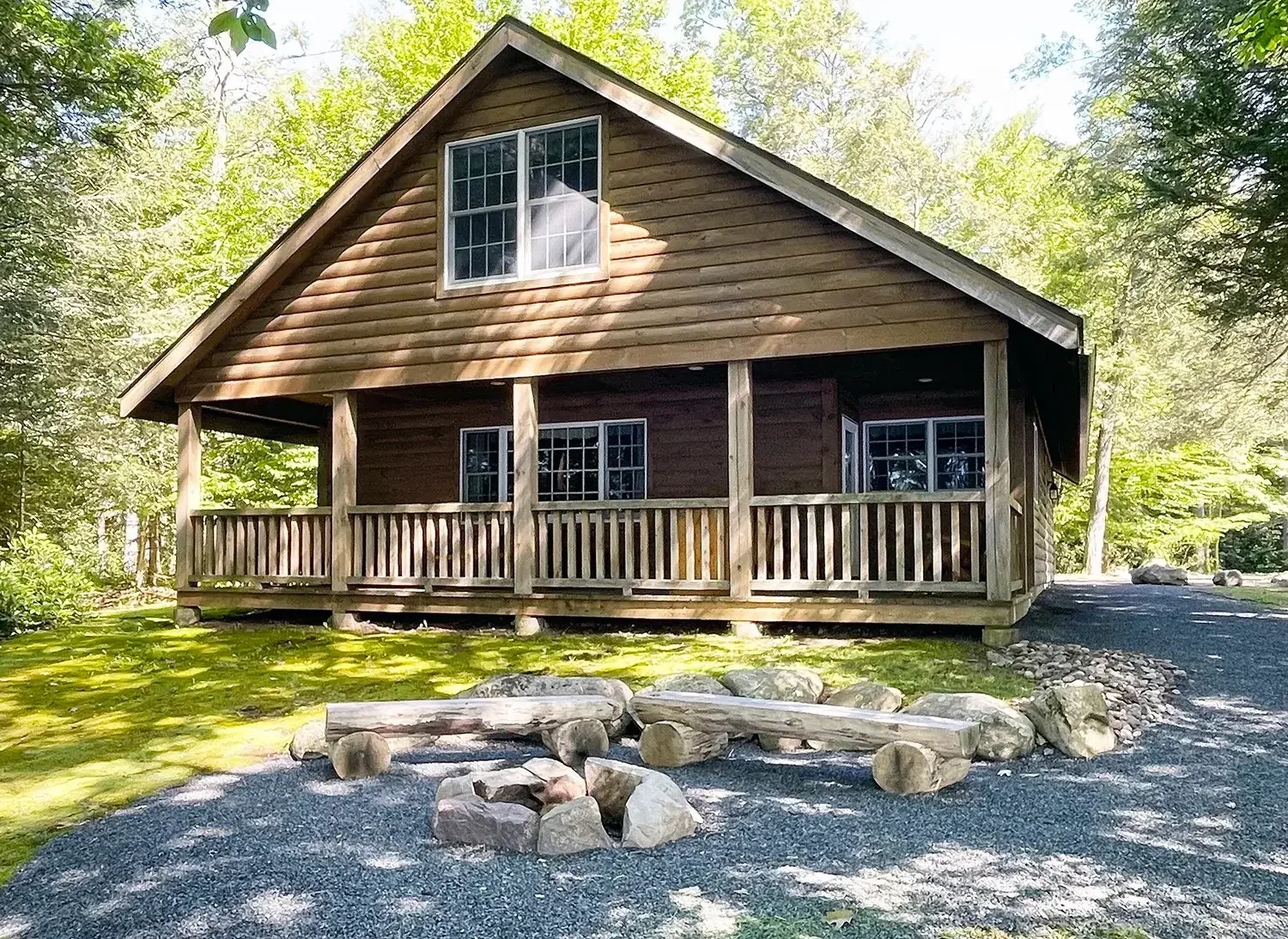 Hemlock Cabin 63 exterior front porch and fire pit at Mountain Springs Lake Resort