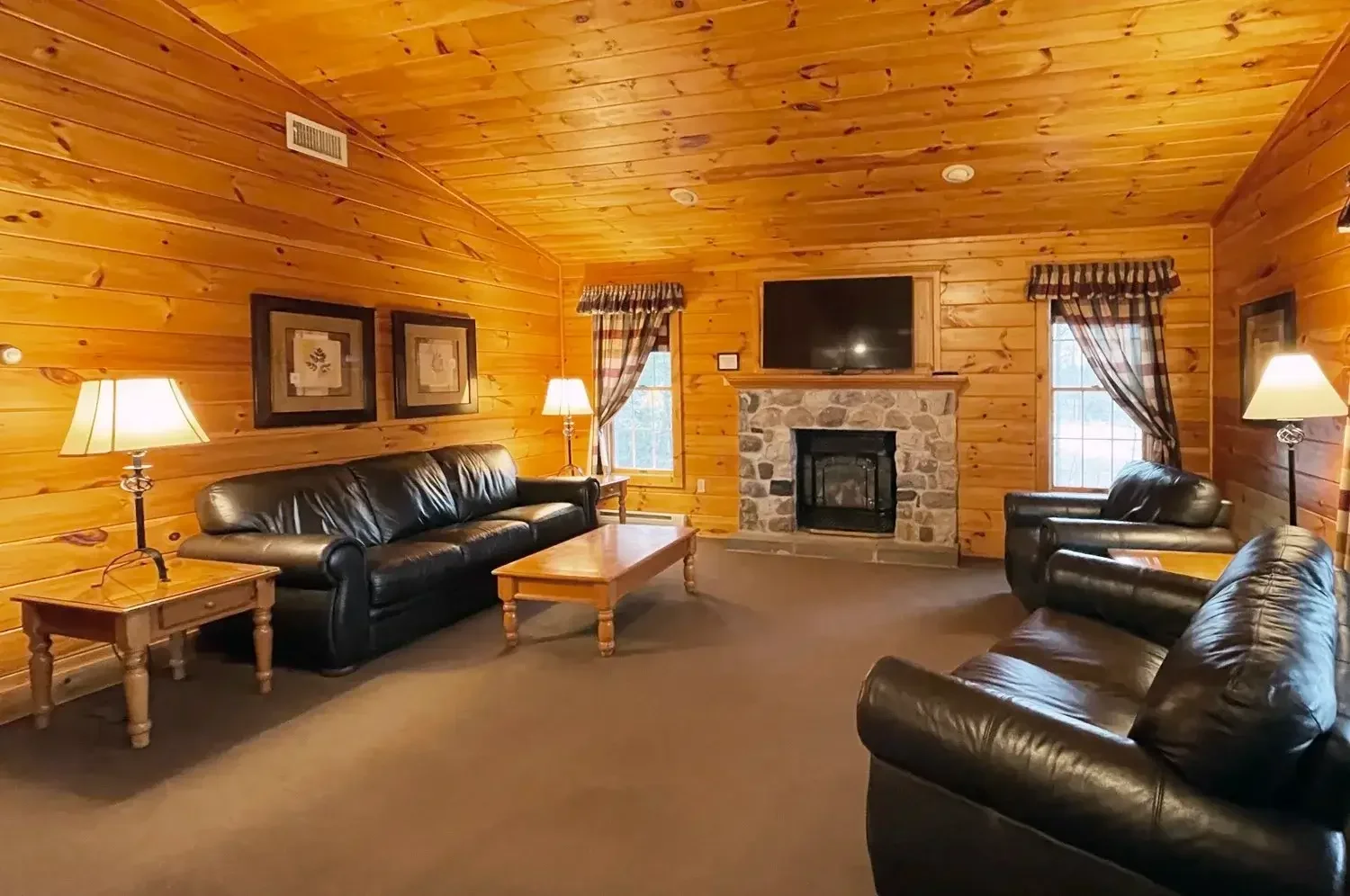 Living room with stone gas fireplace inside Hemlock Cabin #55