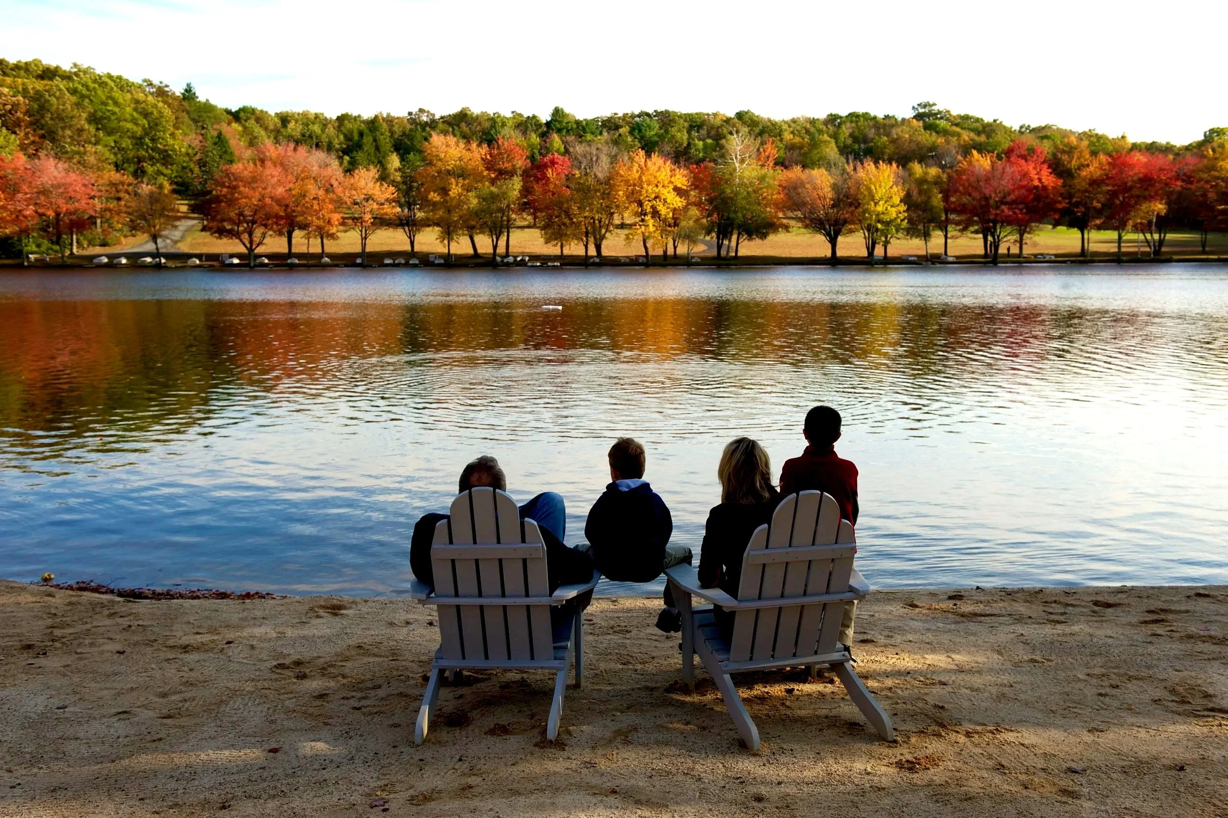 Family enjoying the lake during fall at Mountain Springs Lake Resort in the Pocono Mountains