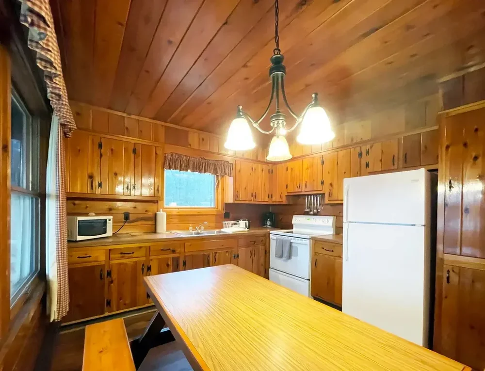 Cabin 39 kitchen with wood cabinets and white appliances