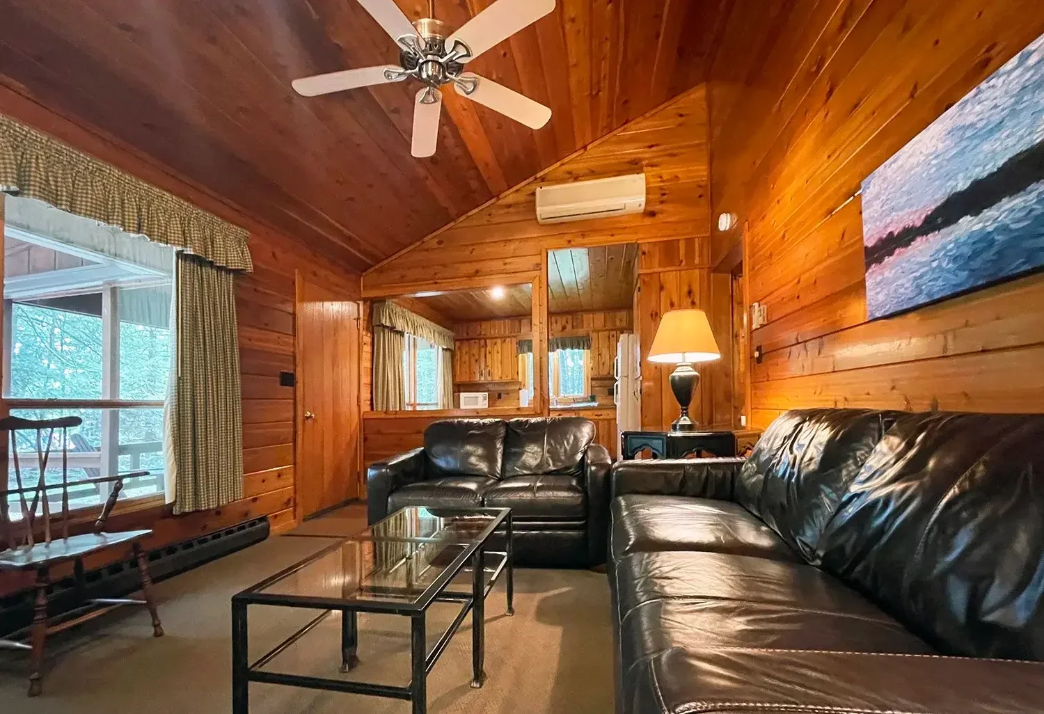 Cabin 40 living room with leather furniture and wood ceiling