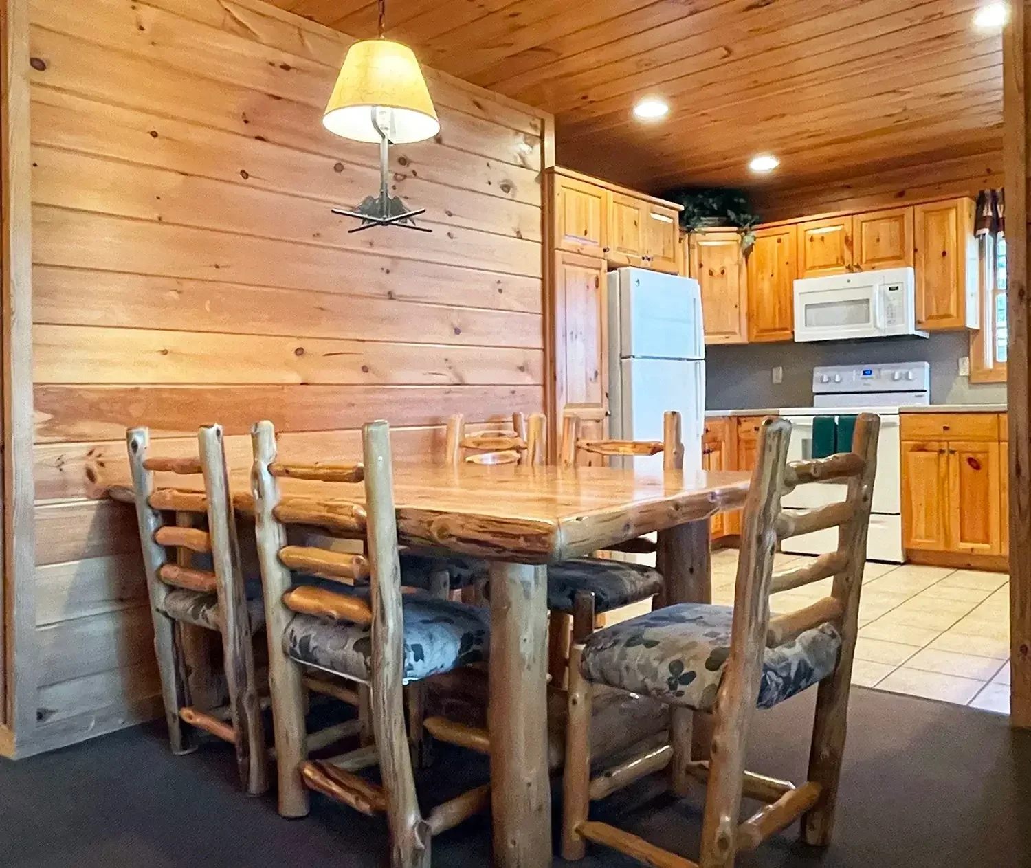 Dining area with log-style table inside Hemlock Cabin #63
