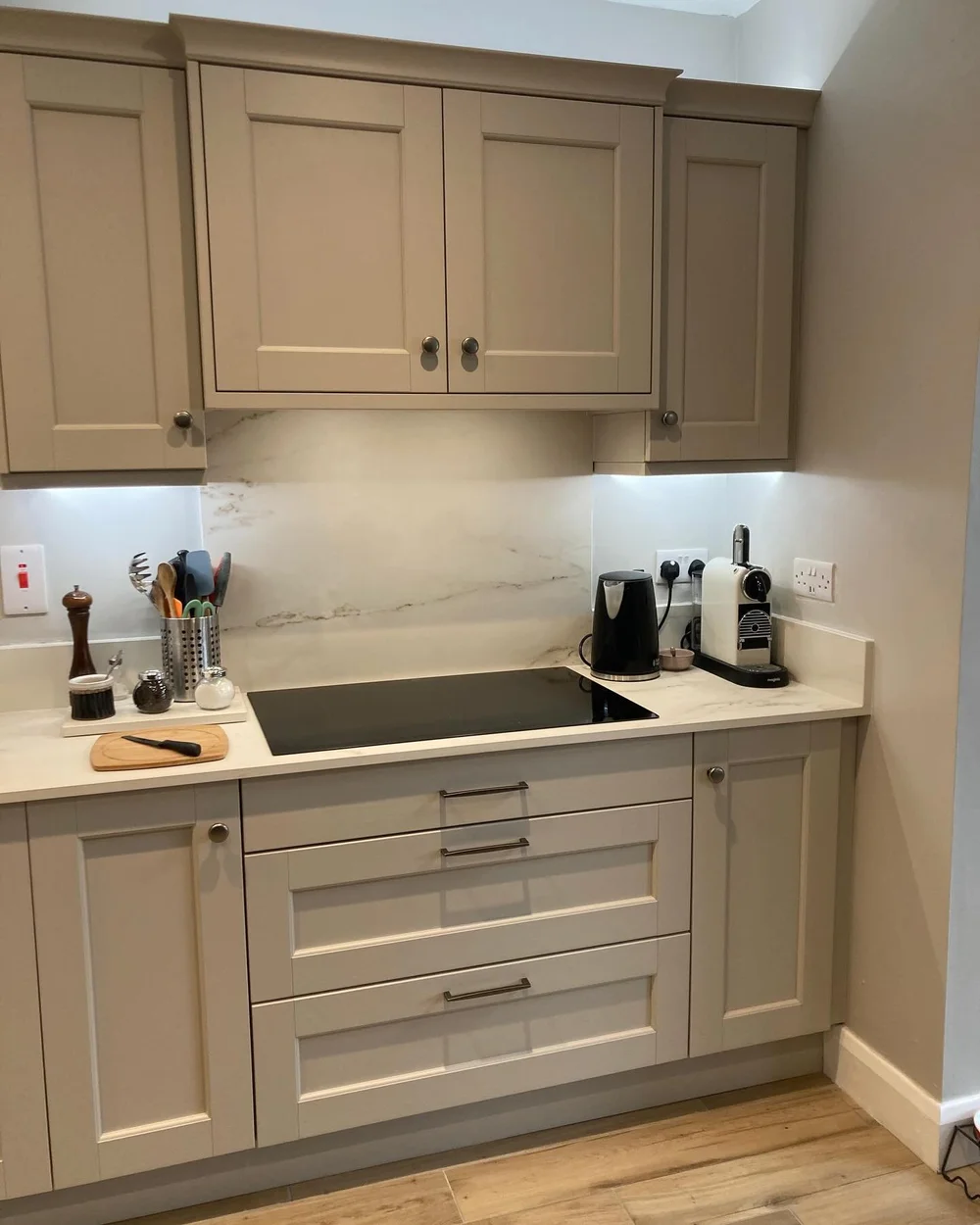 Taupe Bradbury Beaded Shaker cabinetry with an induction hob and drawers