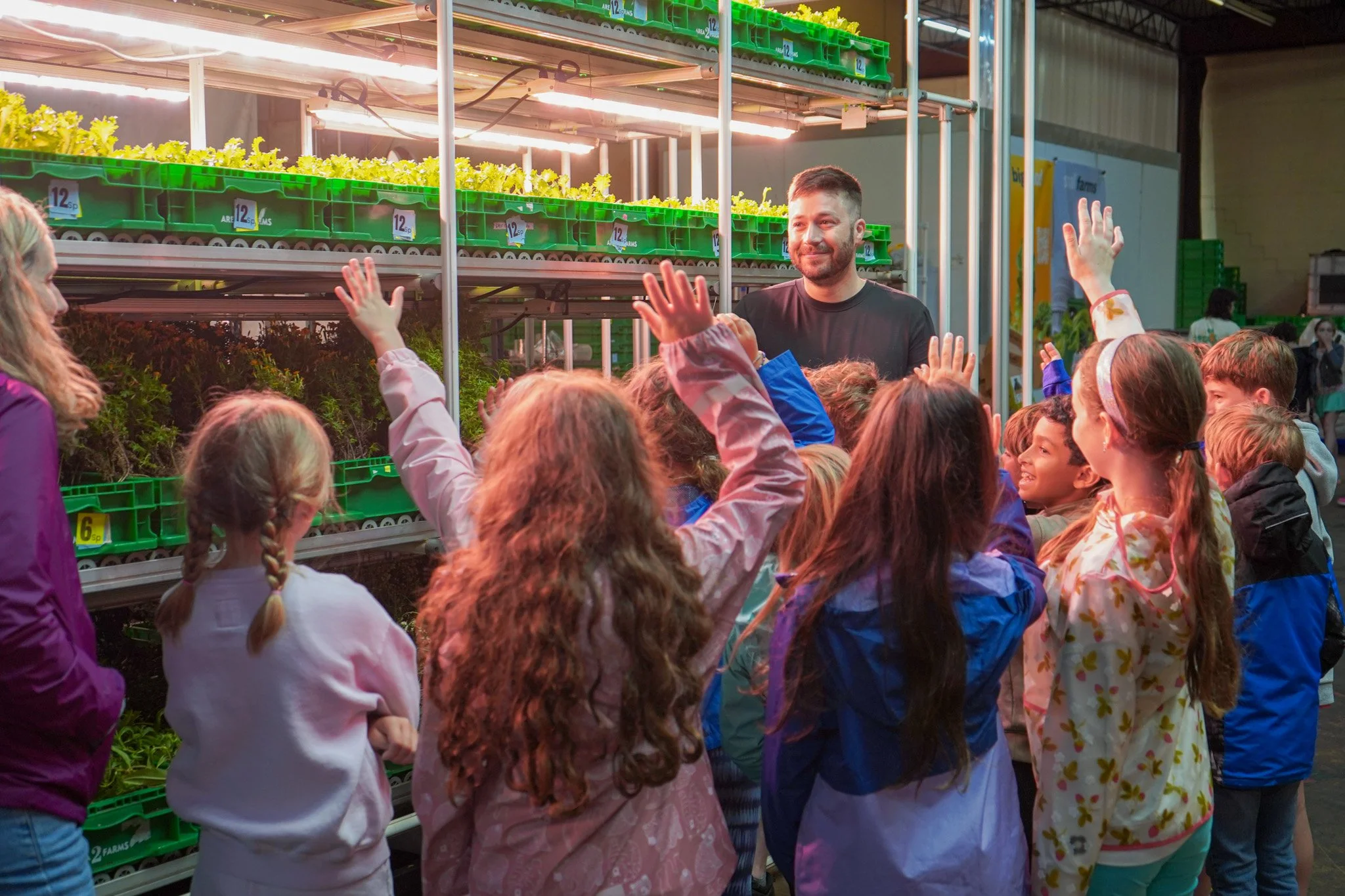 A farmer leading a school group through the Arlington farm