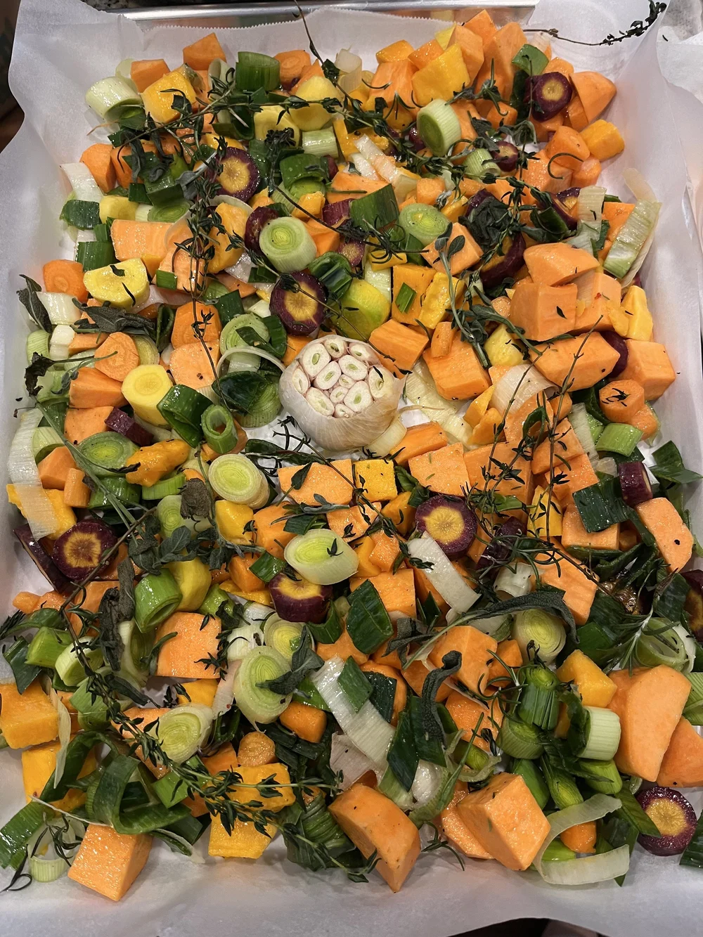 Tray of carrots, leeks, and squash ready to roast