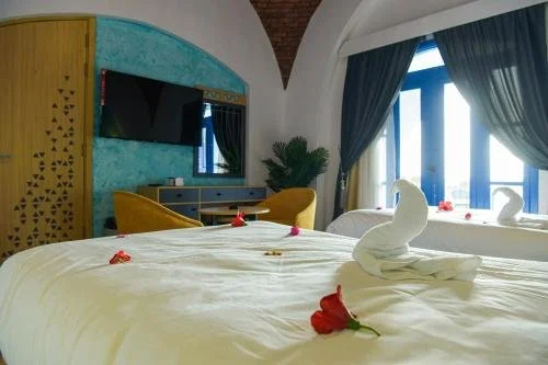 Guest room at New Panorama Resort with arched ceiling and blue accents