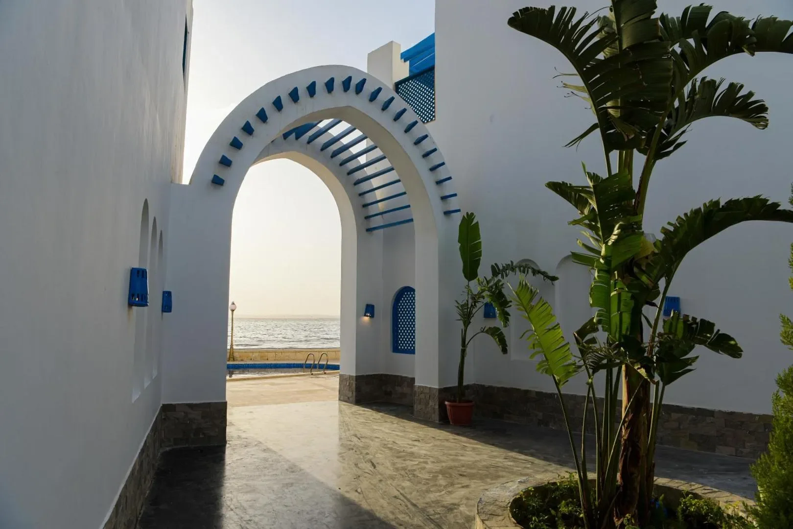 Arched passage at New Panorama Resort opening toward the water
