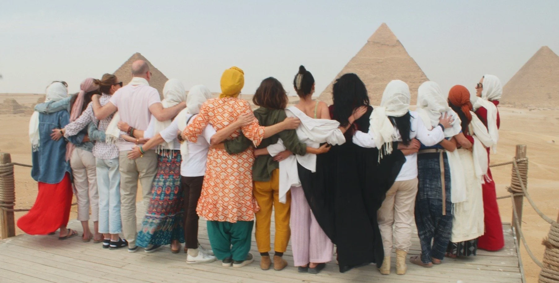 Members of the Order standing arm in arm before the pyramids