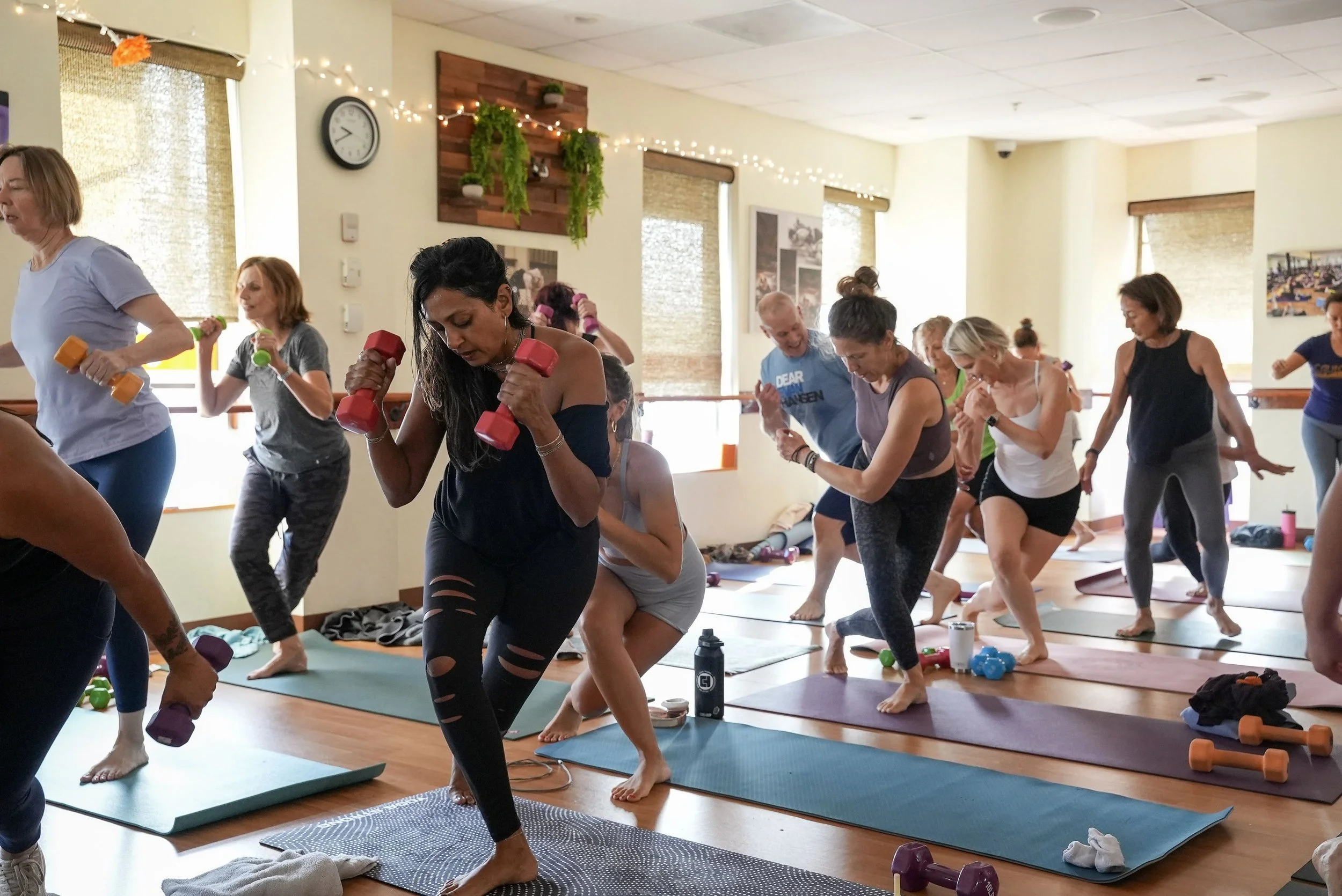 Students exercising with hand weights at Yoga Health Center