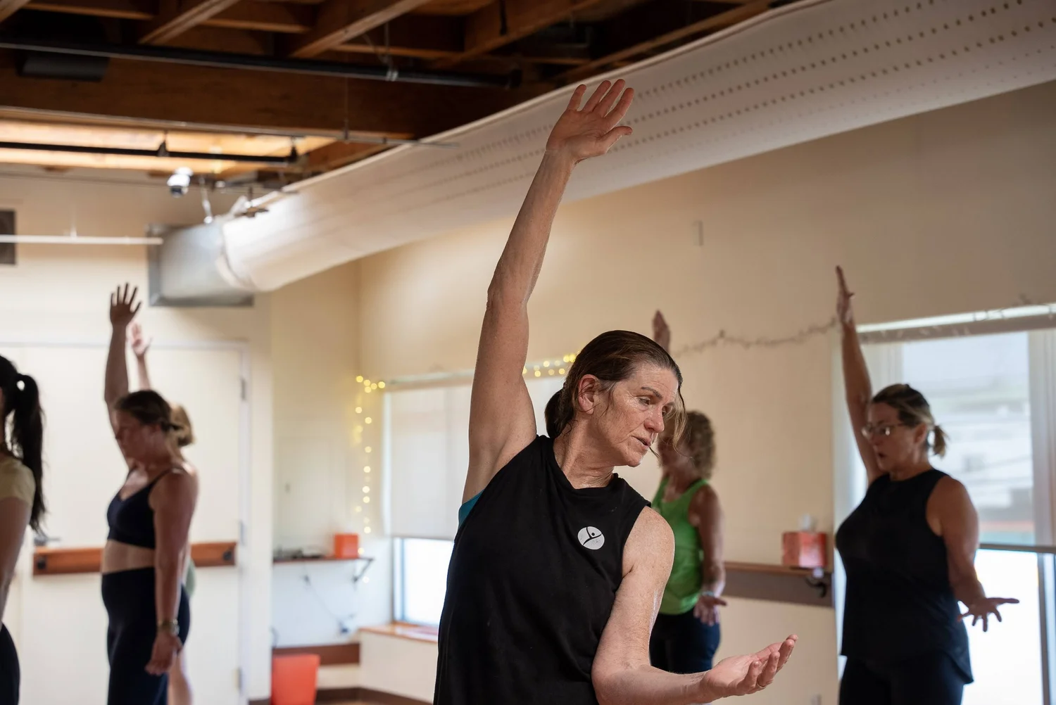 Teacher leading a hot yoga class