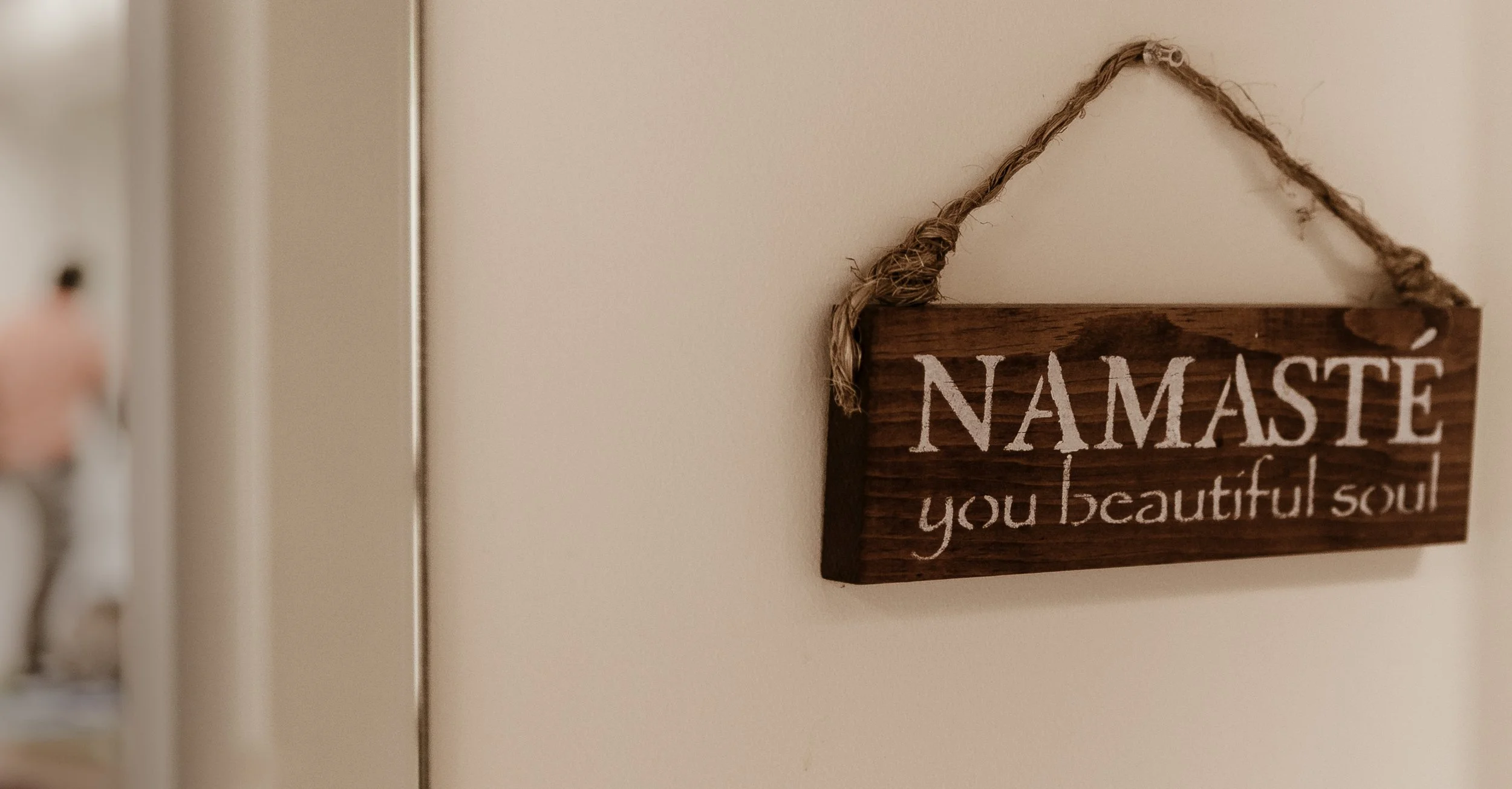 Wooden sign at Yoga Health Center reading Namaste, you beautiful soul