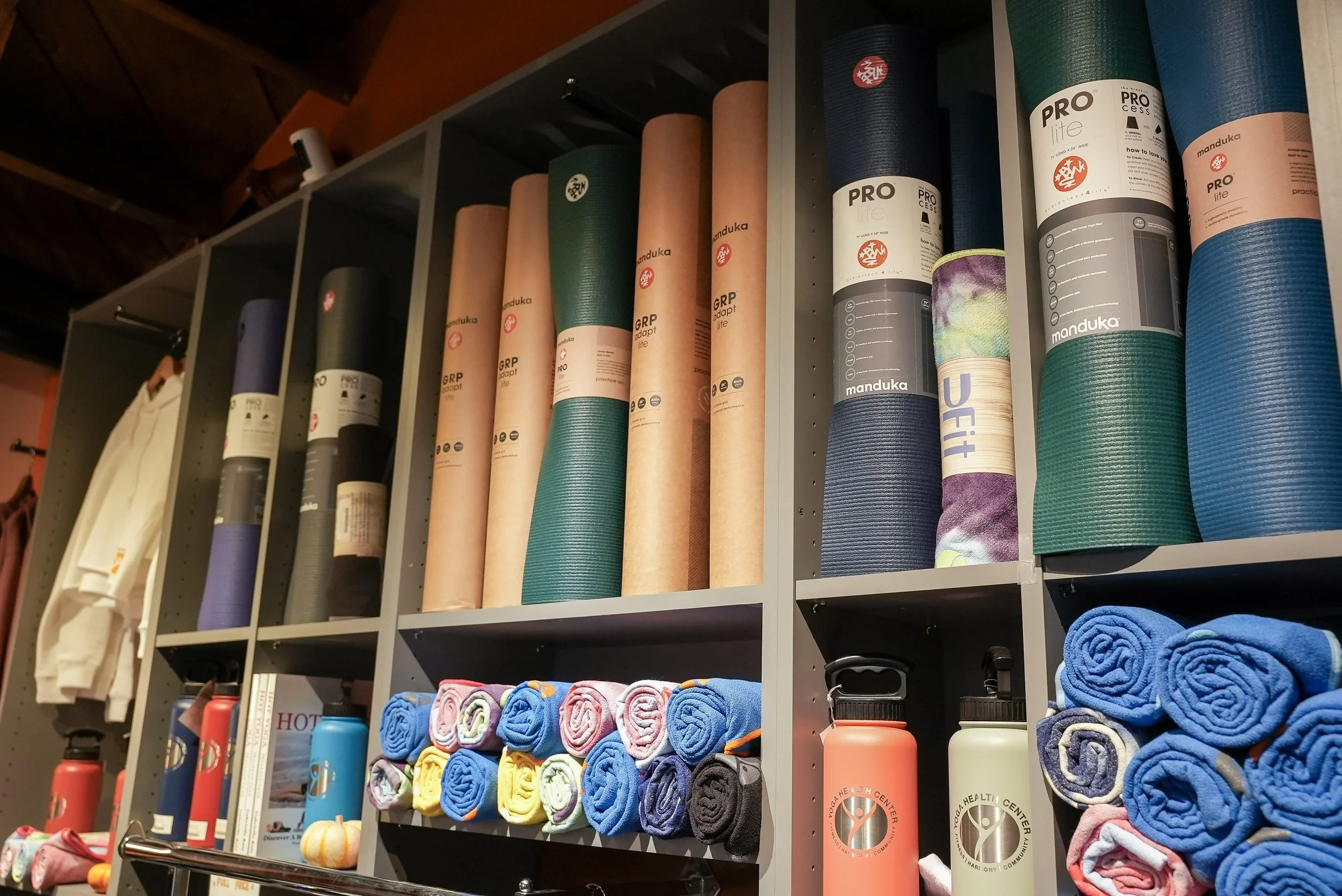 Yoga mats, mat towels, towels and water bottles in the Yoga Health Center boutique
