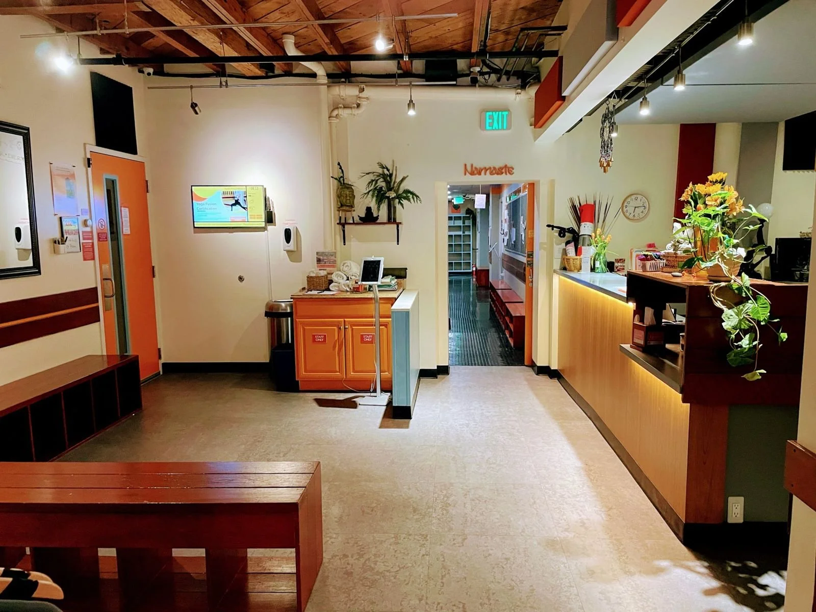 Front desk and lobby at Yoga Health Center, with iPad check-in, towels and cubbies