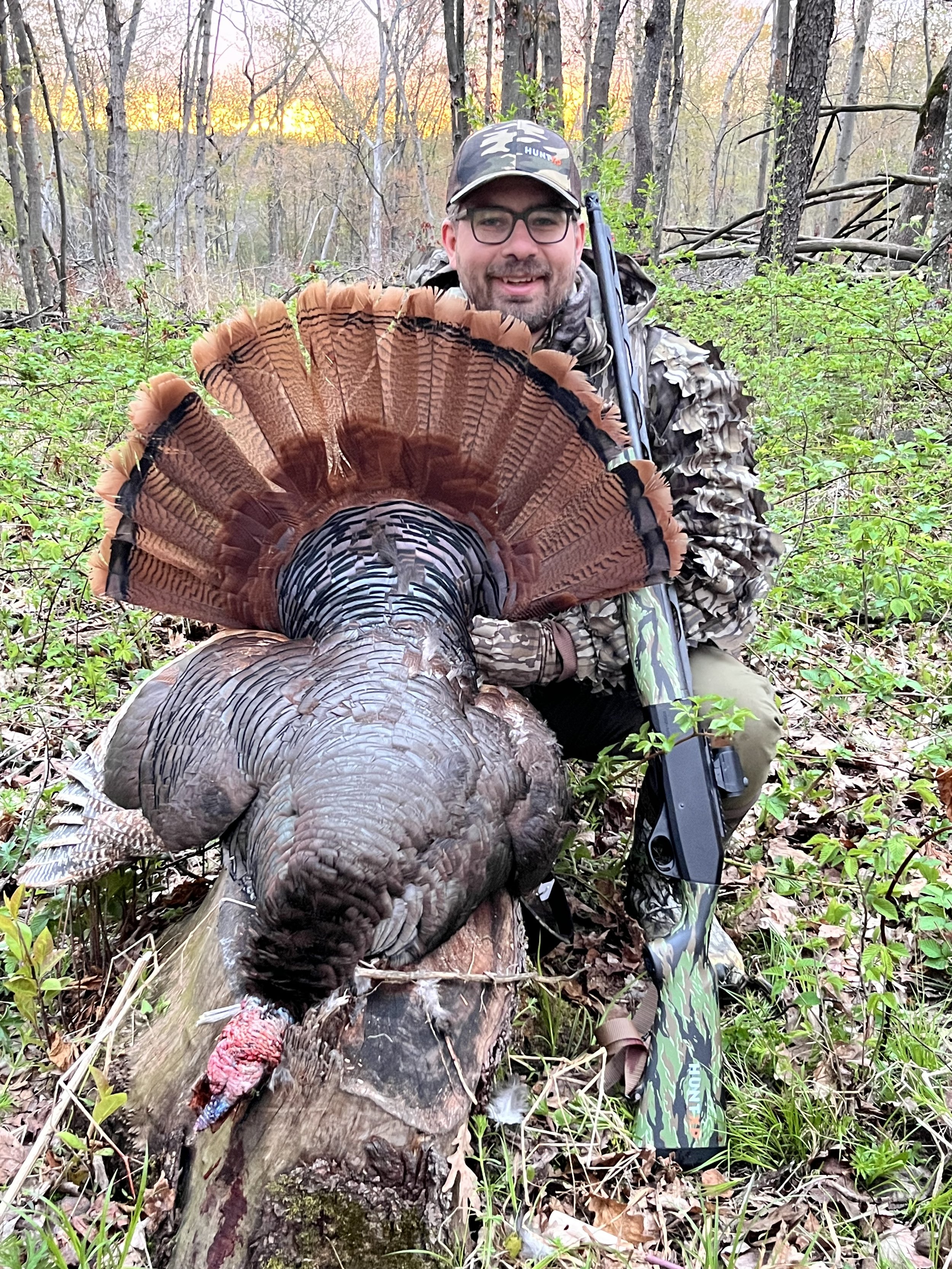 Successful turkey hunter in the woods with a harvested gobbler