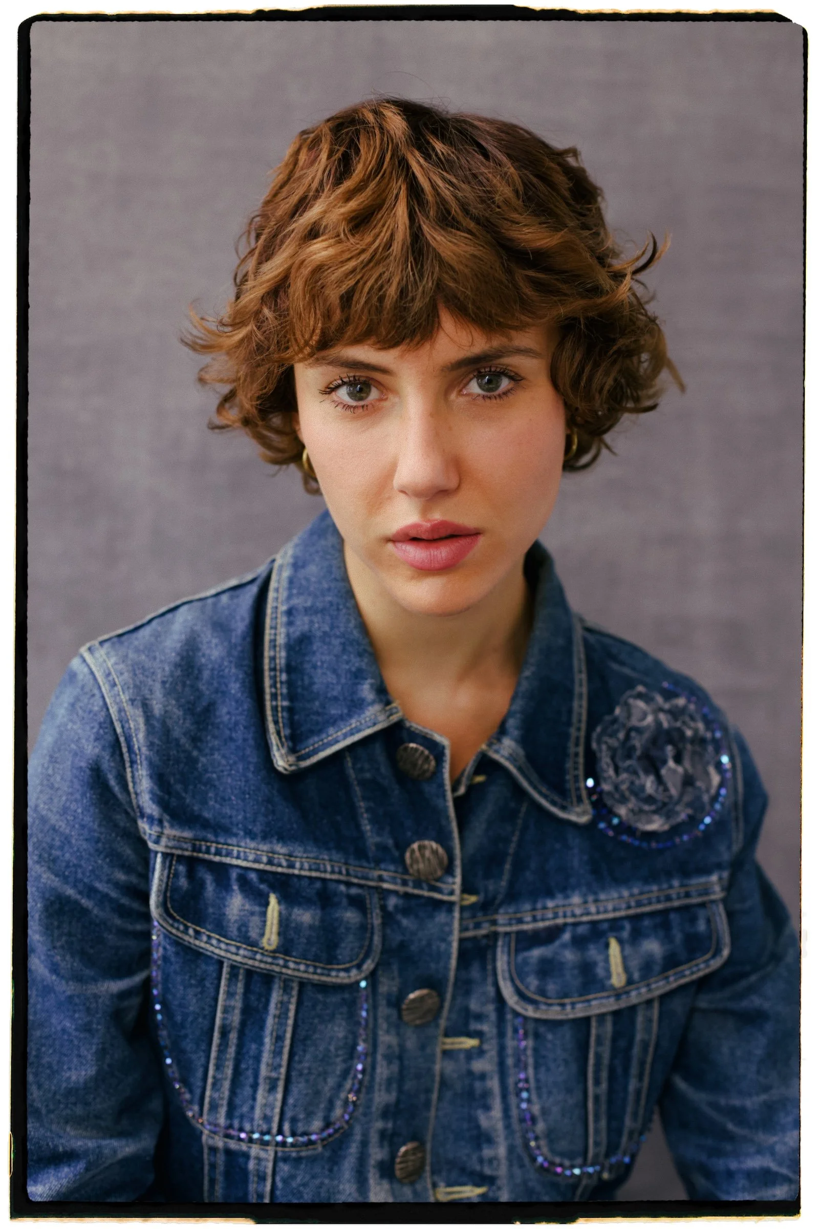 The same portrait finished in theLAB with warm color, grain, and a film border