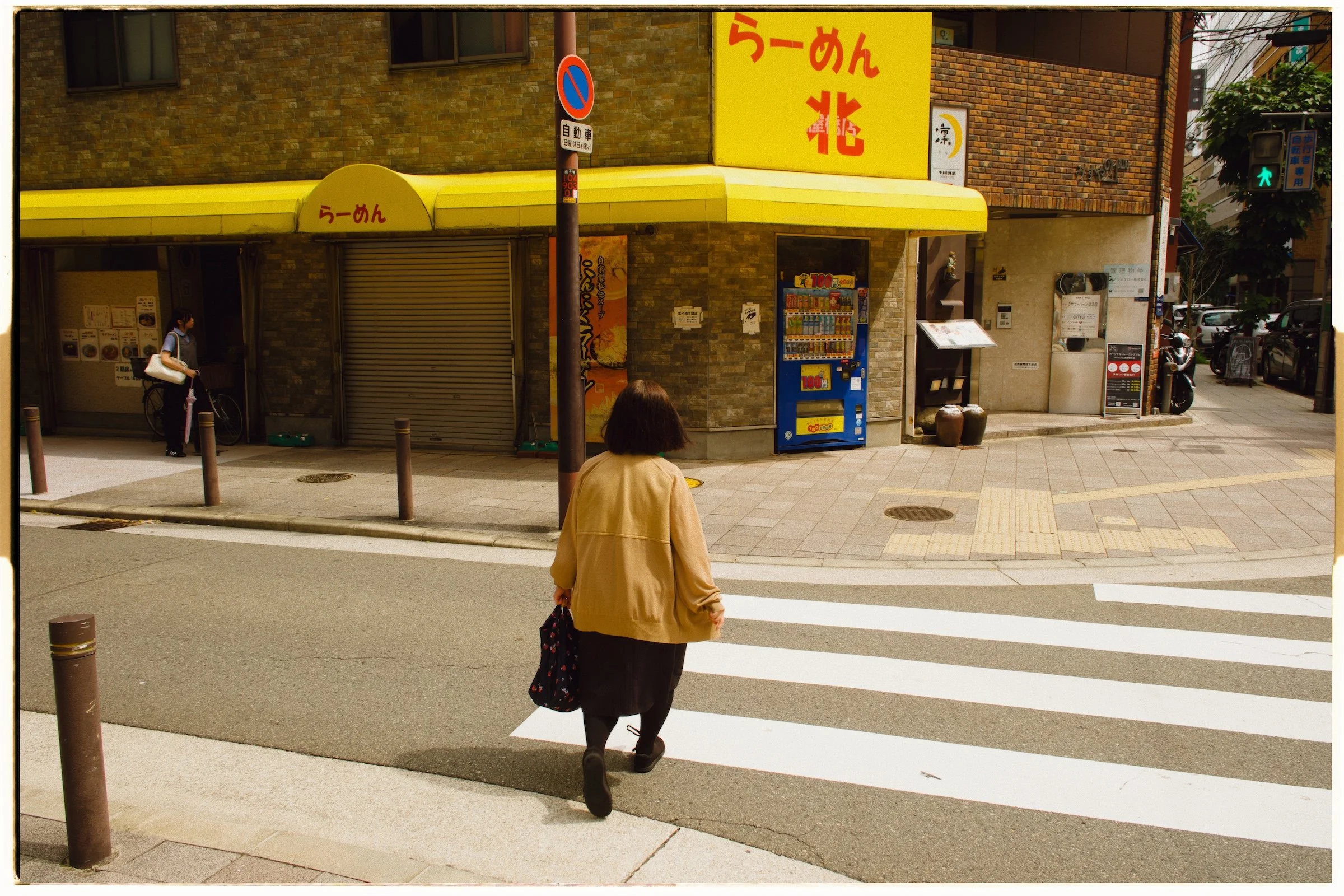 The same street photograph finished in theLAB with golden color, grain, and a film border