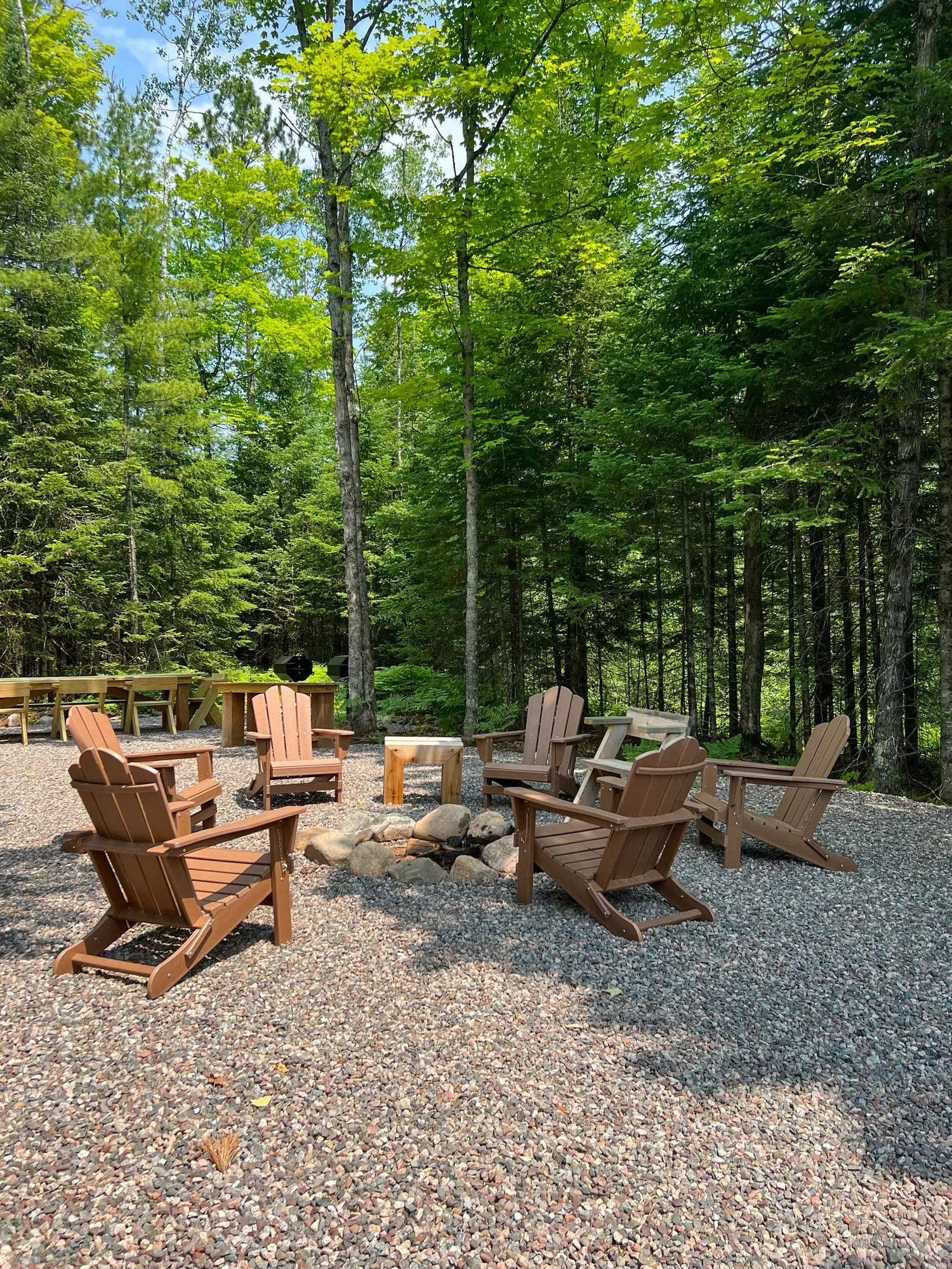 Adirondack chairs around a fire pit