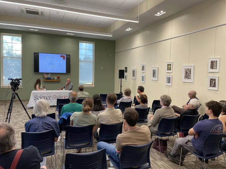Room of people watch an interview at Hadley Public Library.