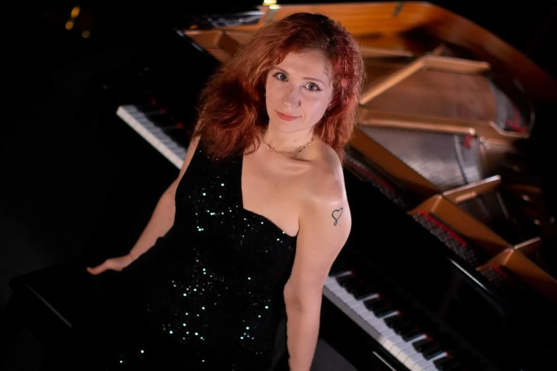 Madalina Danila in a black sequin gown at the piano