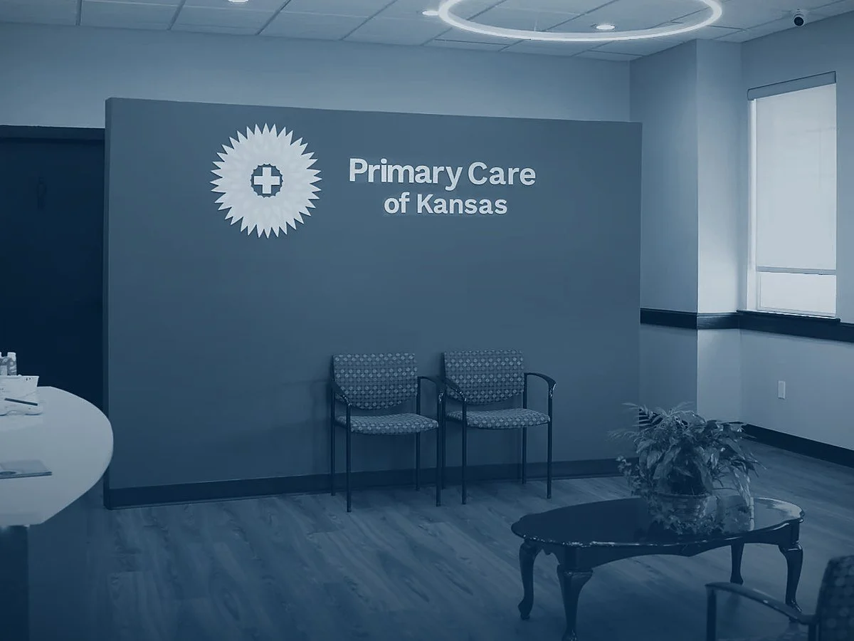 The waiting area at Primary Care of Kansas in Gardner, with the practice name on the wall.
