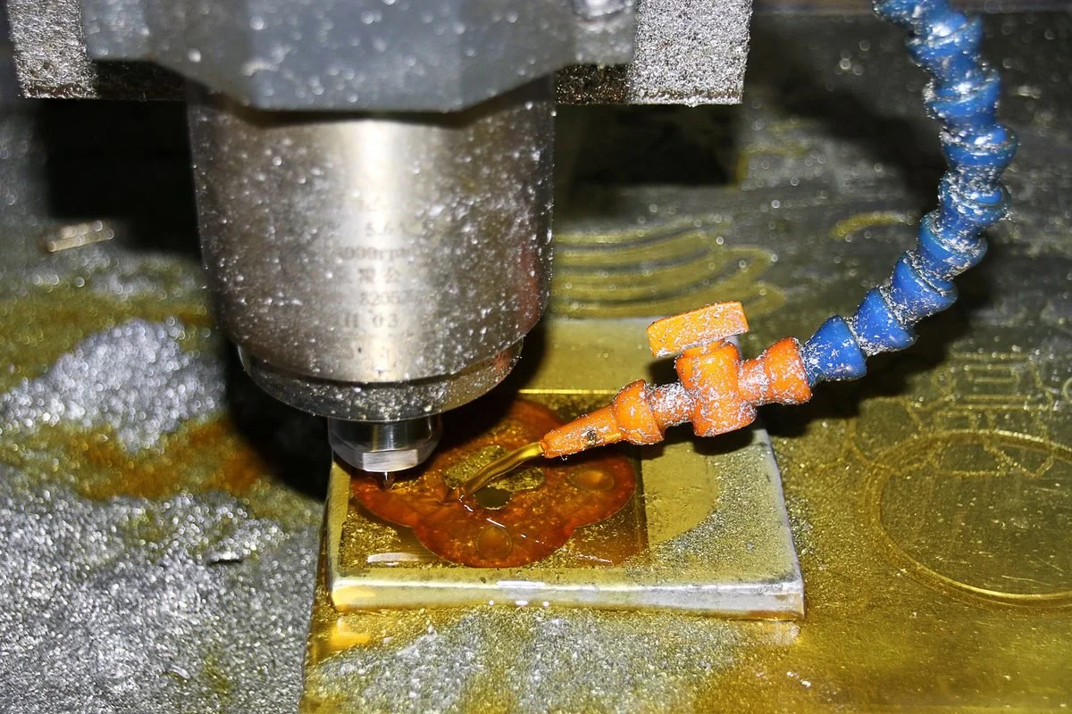 A CNC milling machine cutting a metal part