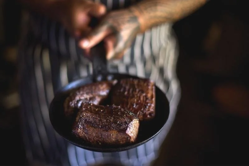 Seared wild New Zealand venison in a cast-iron pan