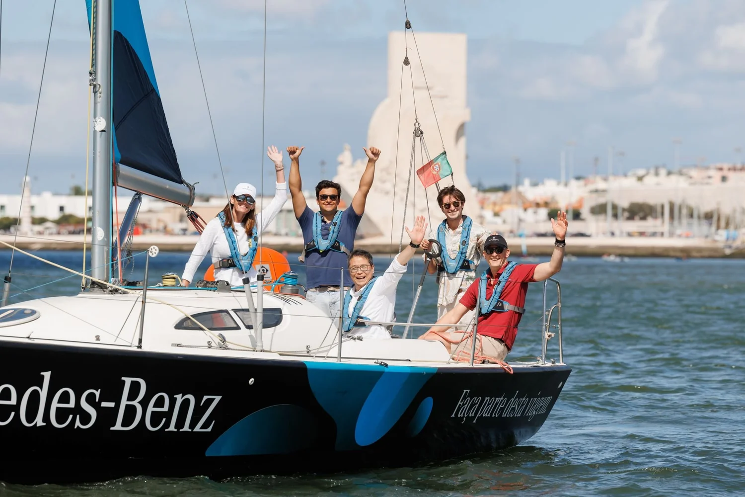 Guests waving from a sailboat