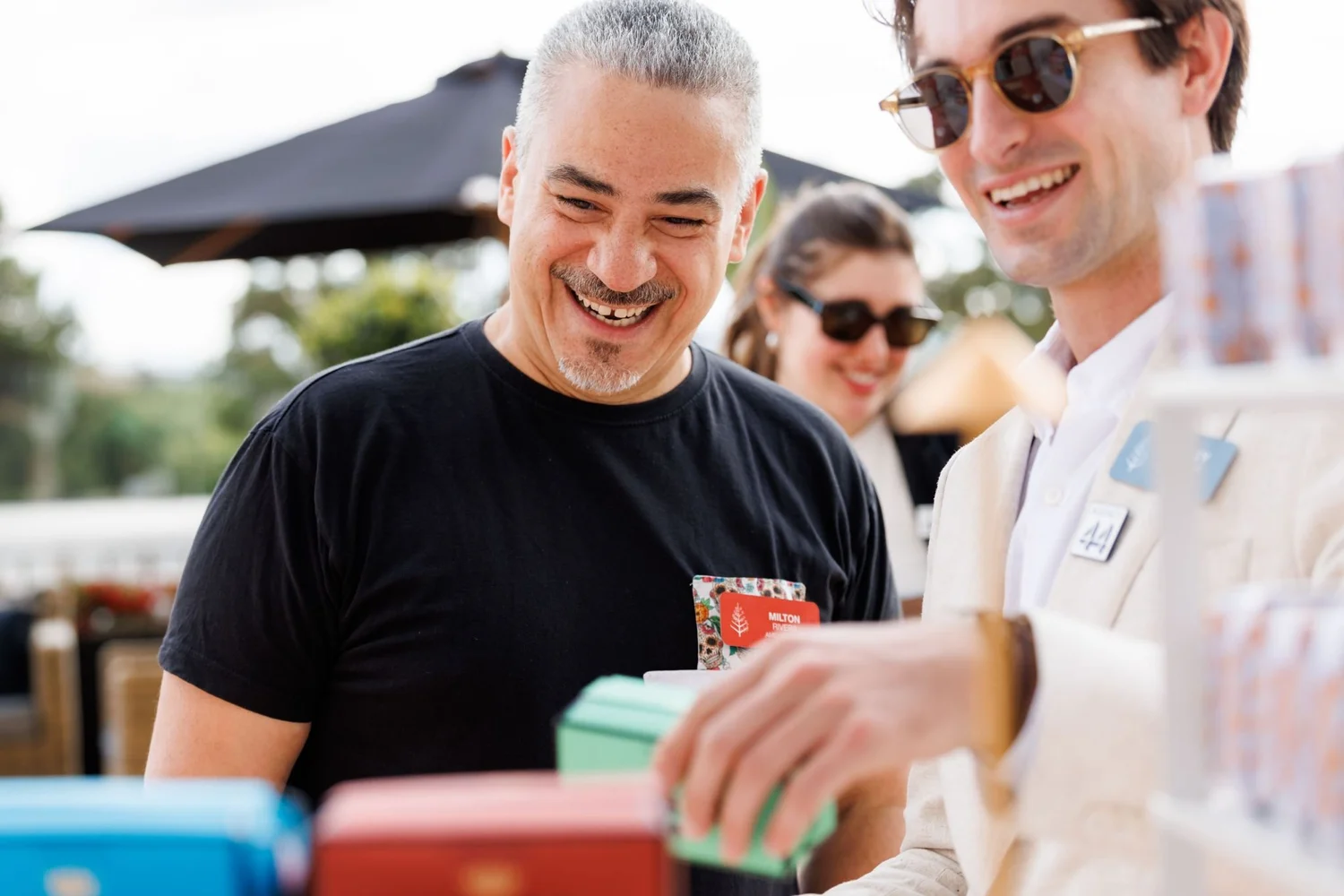 Guests laughing at an outdoor gifting table